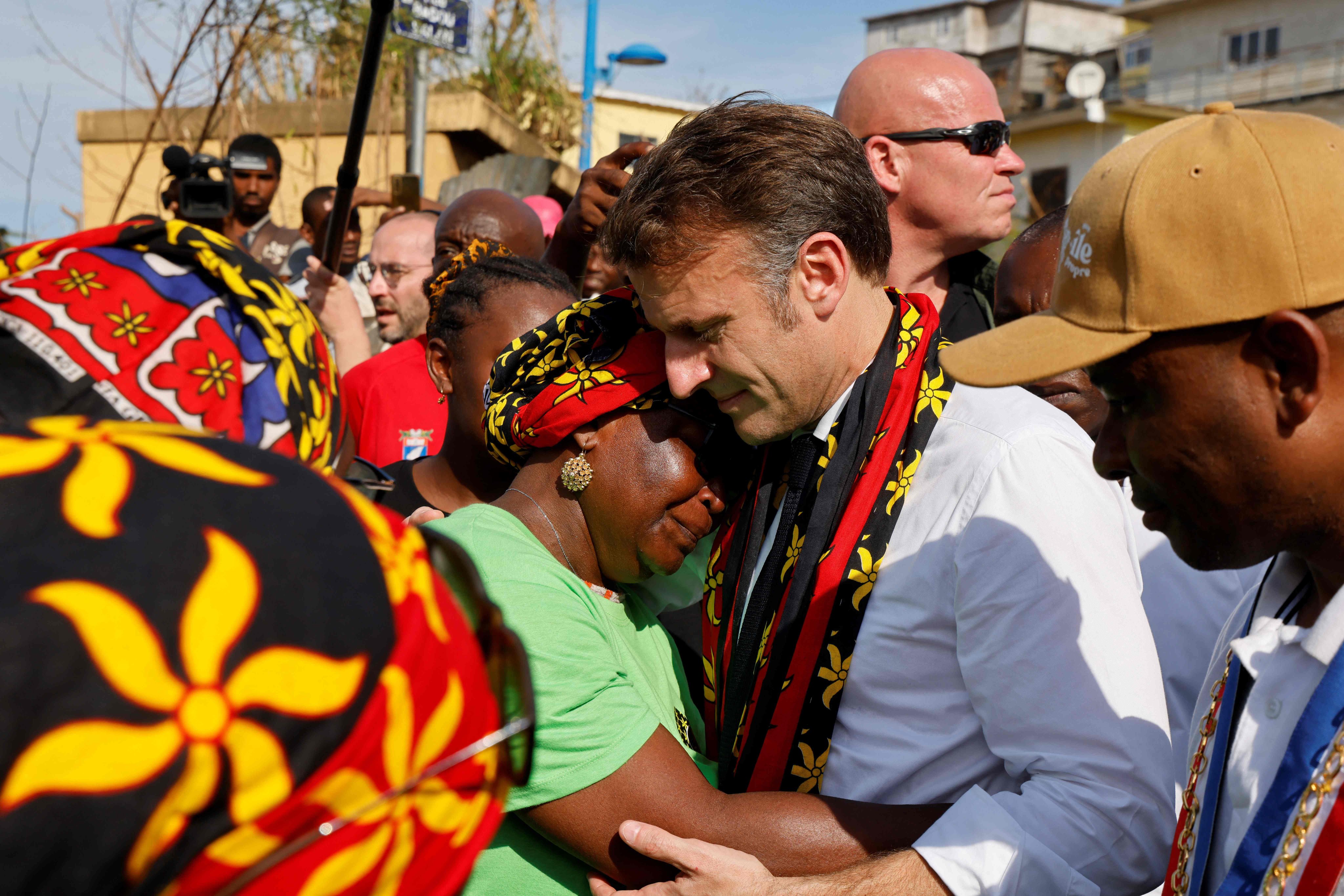 France’s President Emmanuel Macron embraces a woman during his visit to Mayotte following the cyclone. Photo: AFP