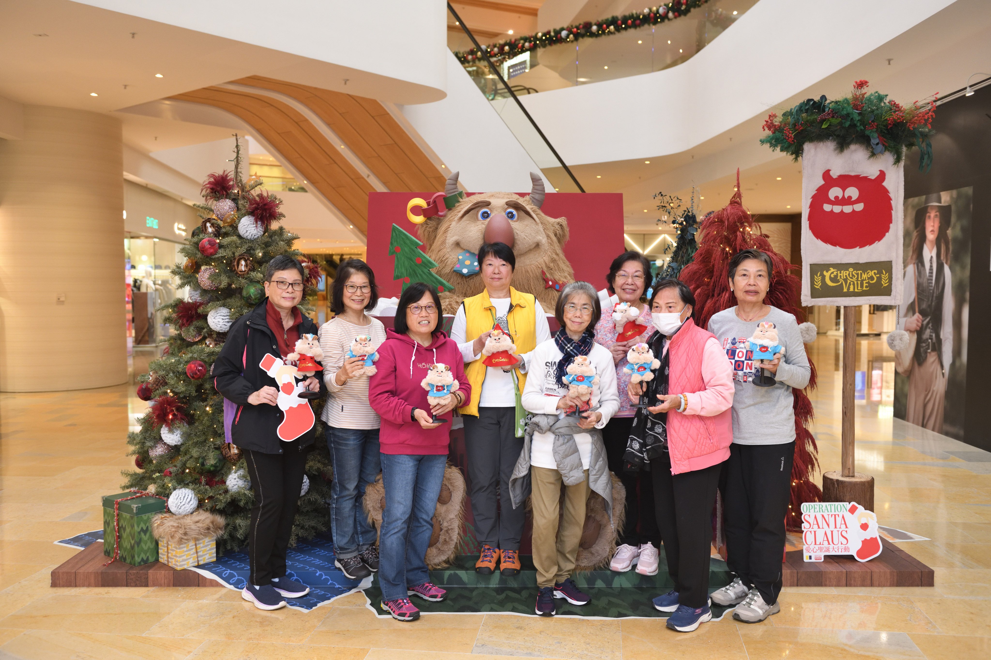 Members of the Methodist Epworth Village Community Centre learn how to make monster-themed tote bags, charms and wreaths at ChristmasVille in Pacific Place. Photo: Lam Lui-kong