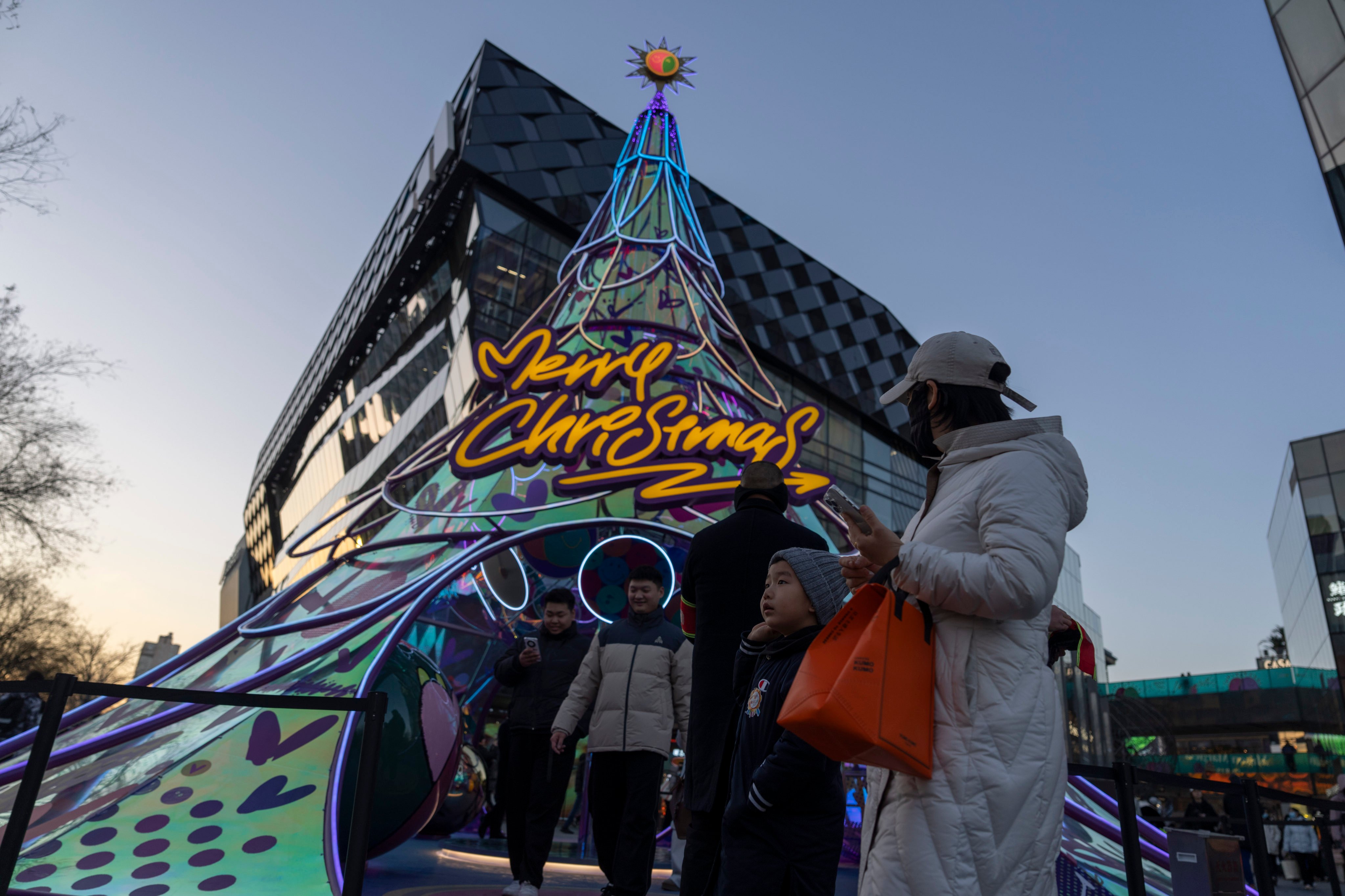 Visitors at a shopping centre in Beijing on Sunday. Photo: AP Photo