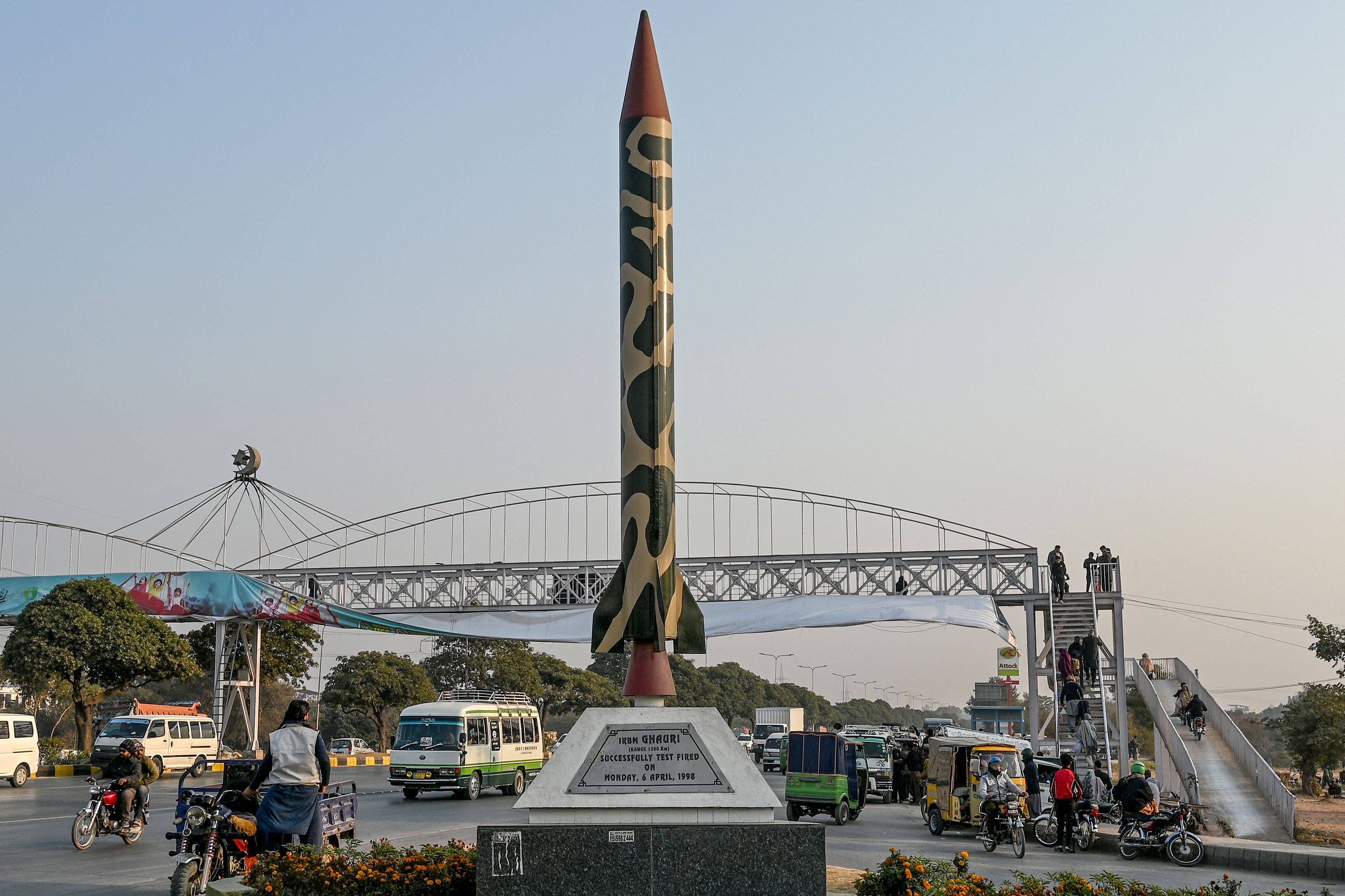 Commuters ride past a replica of Pakistan’s Ghauri ballistic missile along a road in Islamabad. Photo: AFP