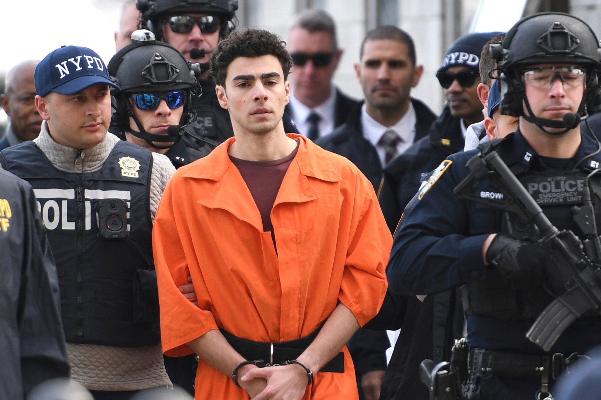 Luigi Mangione, a suspect in the fatal shooting of UnitedHealthcare CEO Brian Thompson, is escorted by police in New York on Thursday. Photo: AP