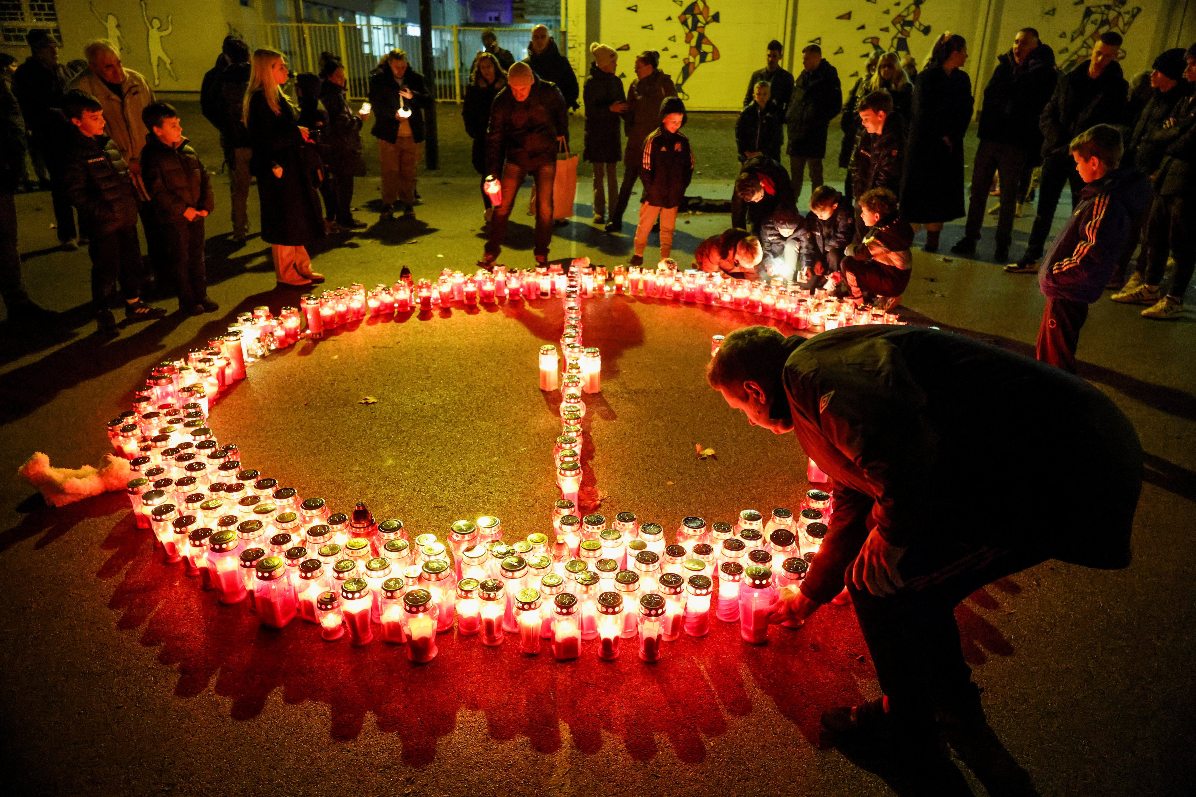 People lay candles following a deadly knife attack at a primary school in Zagreb, Croatia, on Friday. Photo: Reuters