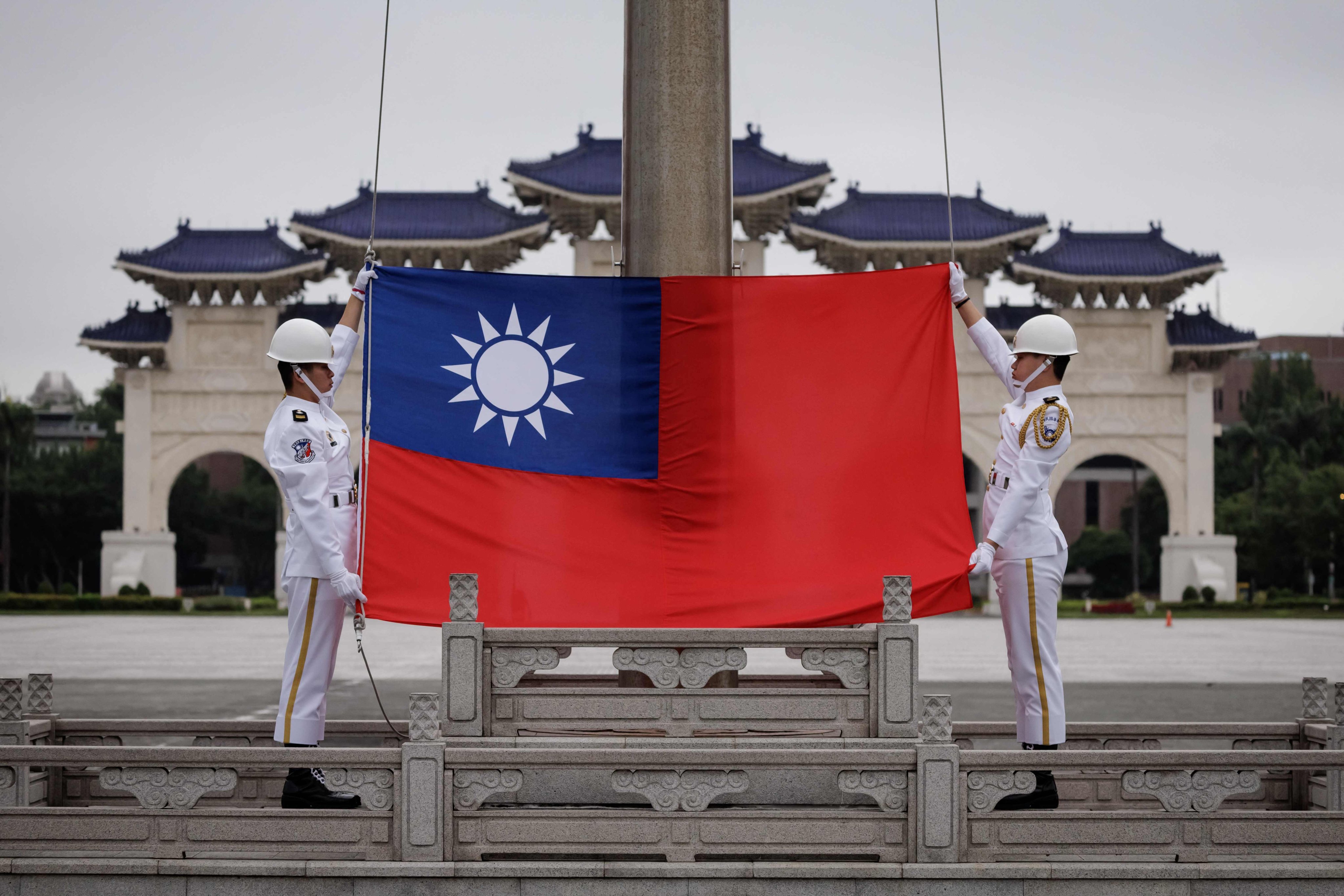 Honour guards raise Taiwan’s flag at the Chiang Kai-shek Memorial Hall in Taipei. The White House has announced military support worth US$571.3 million to Taiwan, along with US$295 million in arms sales approved by the State Department. Photo: AFP 