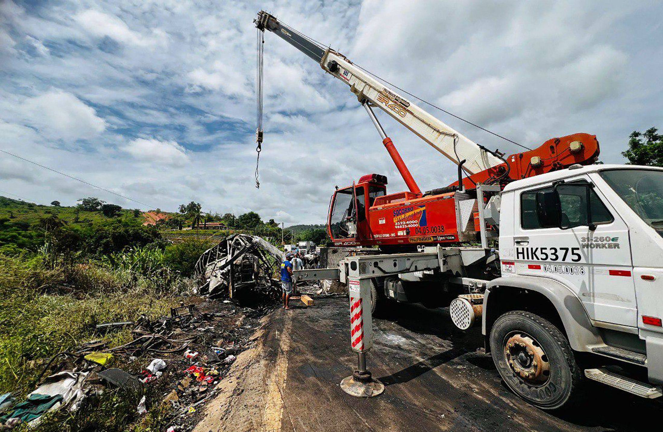 A crane works on the site of a crash in Teofilo Otoni, Minas Gerais state in Brazil. Photo: AFP/Minas Gerais Fire Department