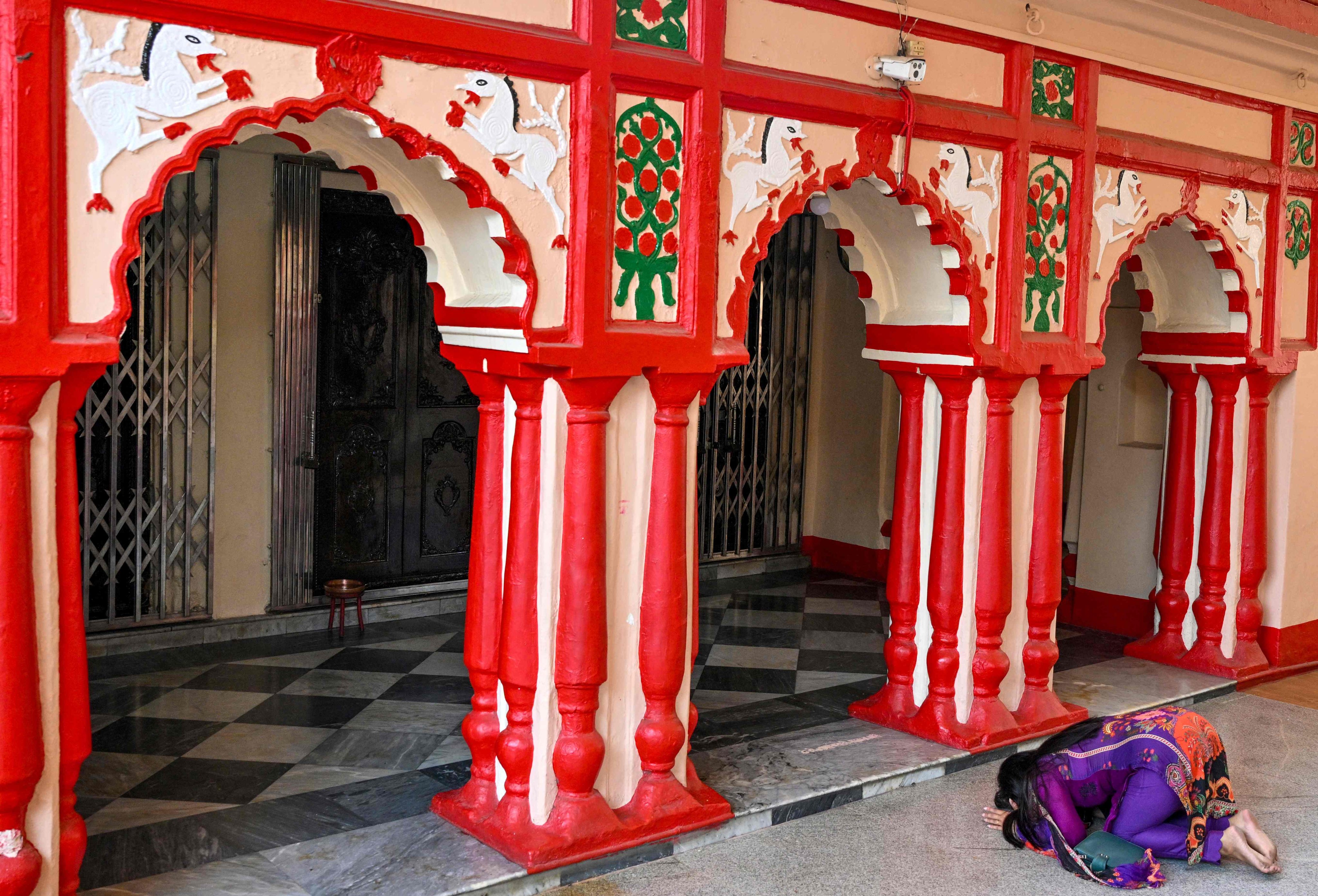 A Hindu devotee prays at Dhakeshwari Temple in Dhaka. For generations, the small Hindu temple outside the capital in Muslim-majority Bangladesh was a quiet place to pray -- before arsonists ripped open its roof this month in the latest post-revolutionary unrest. PhotoL: AFP