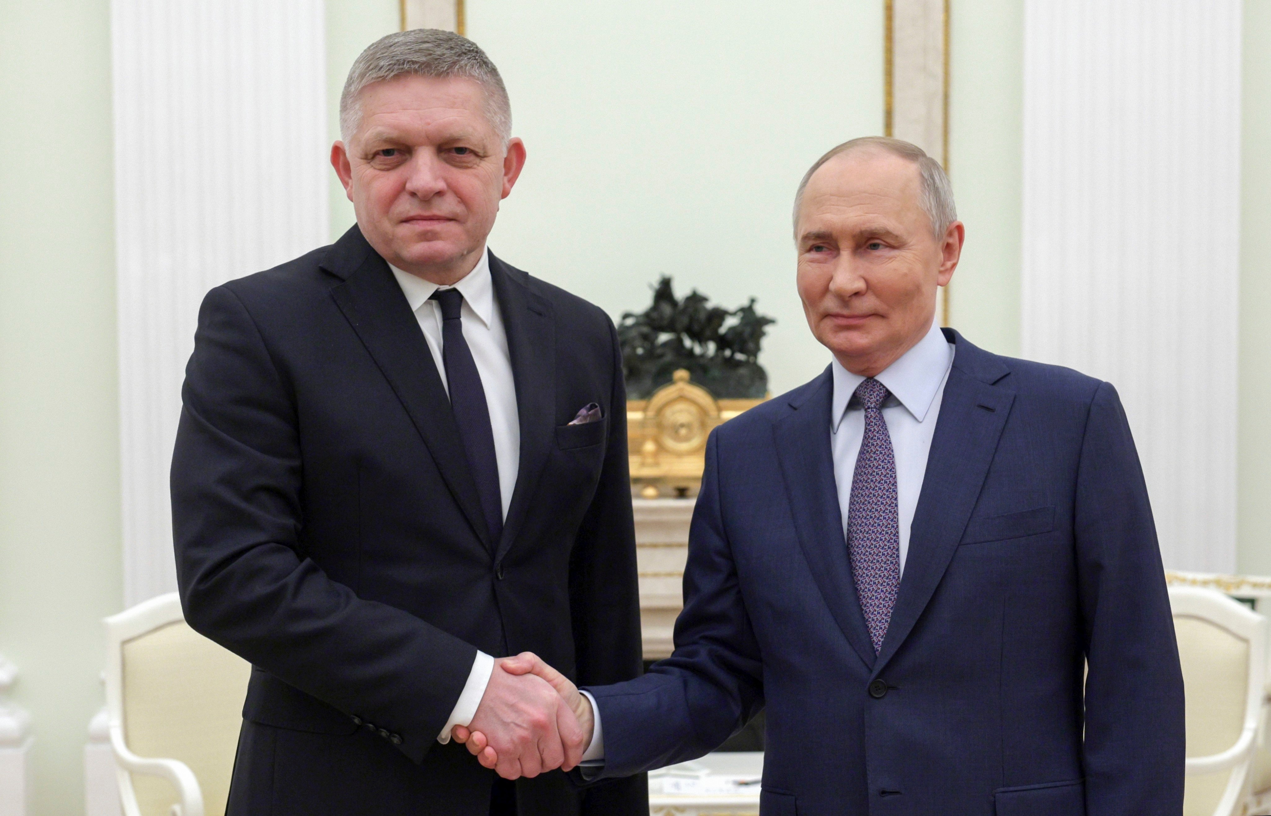 Russian President Vladimir Putin, right, and Slovak Prime Minister Robert Fico shake hands during their meeting at the Kremlin in Moscow, Russia on Sunday. Photo: Sputnik, Kremlin Pool Photo via AP