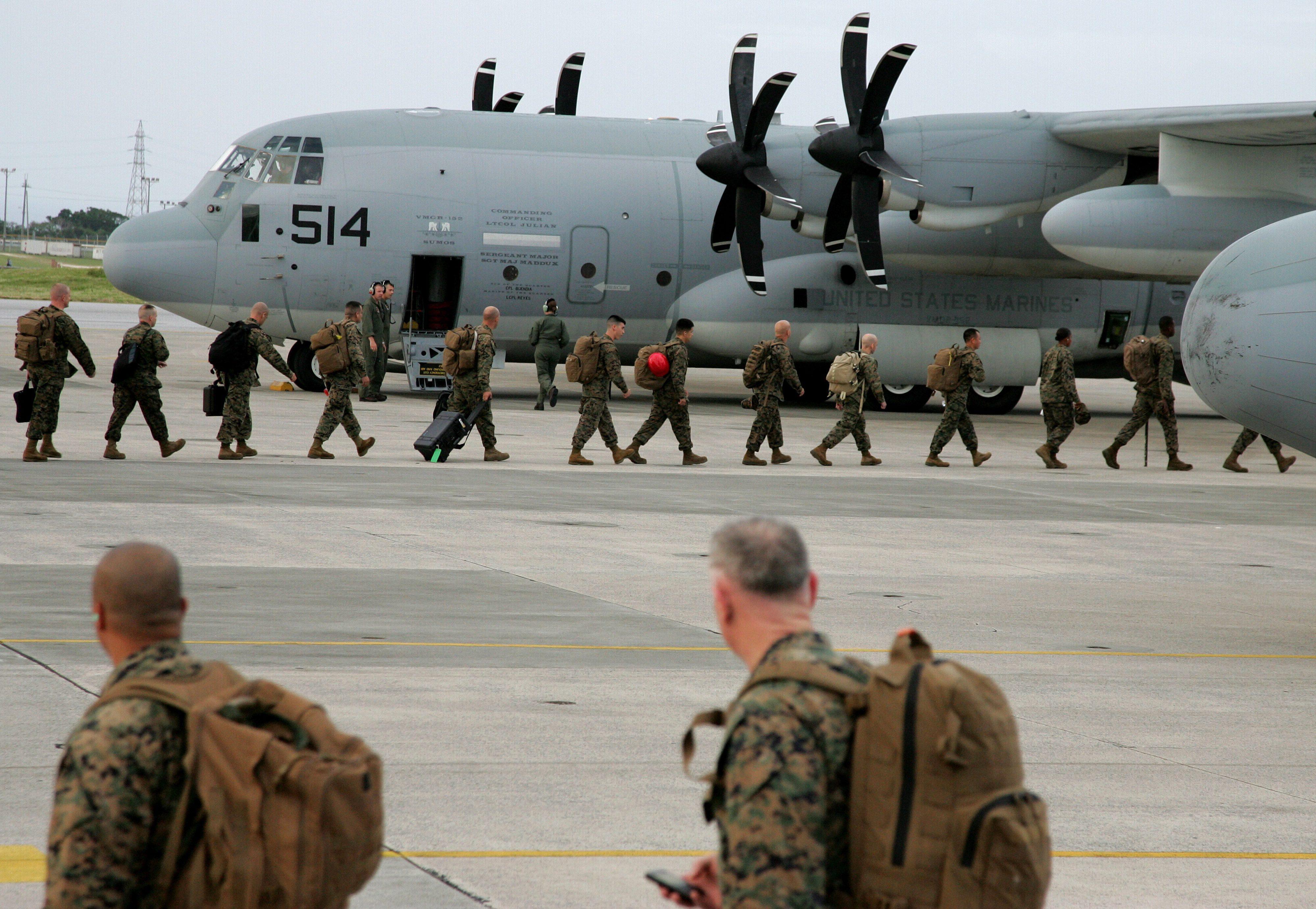 Japan-based US Marine Corps soldiers embark an aircraft in Ginowan, Okinawa Prefecture, southern Japan, in November 2013. Photo: EPA