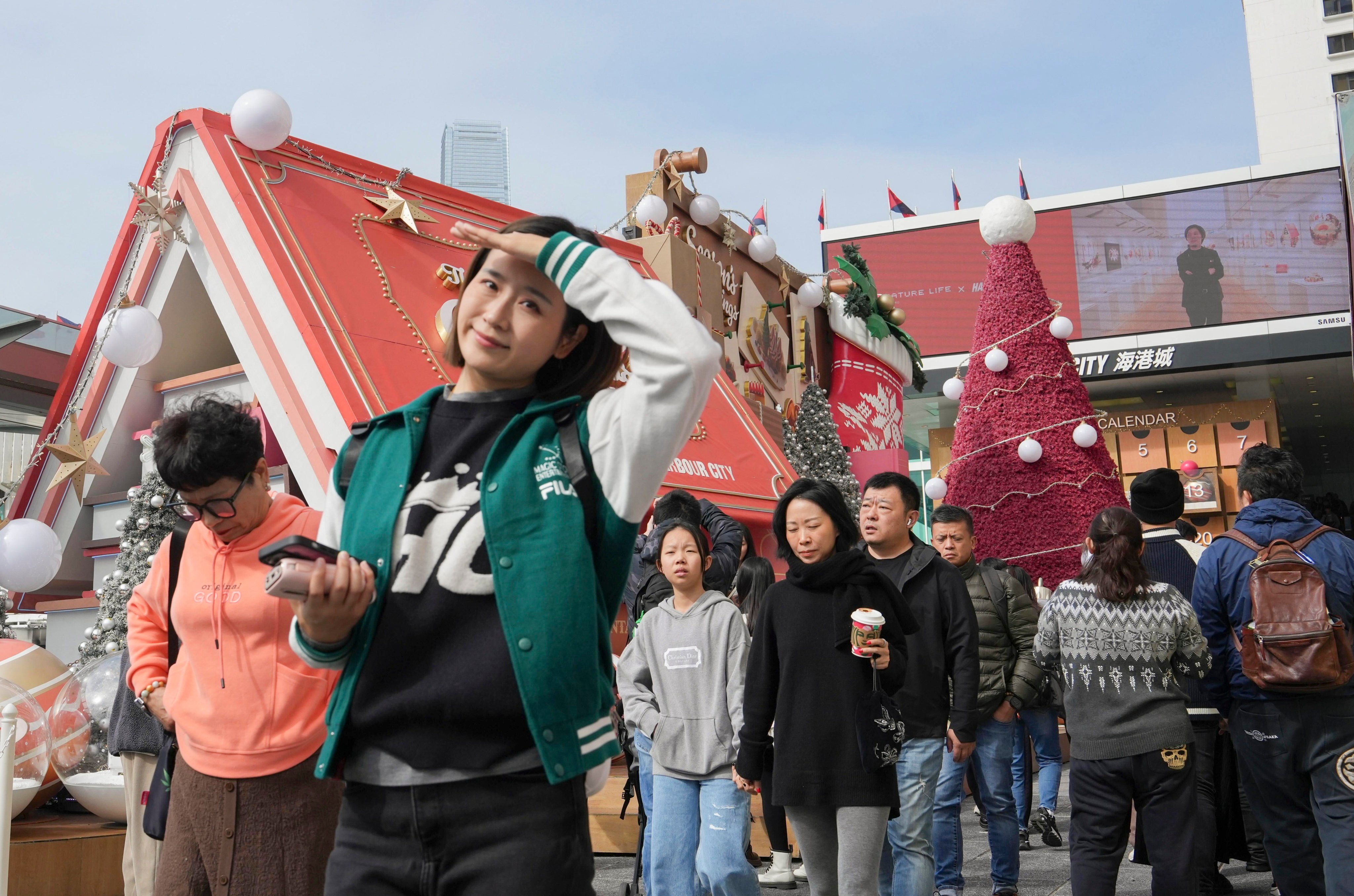 Visitors outside a shopping centre in Tsim Sha Tsui on Christmas Eve. Photo: Sun Yeung