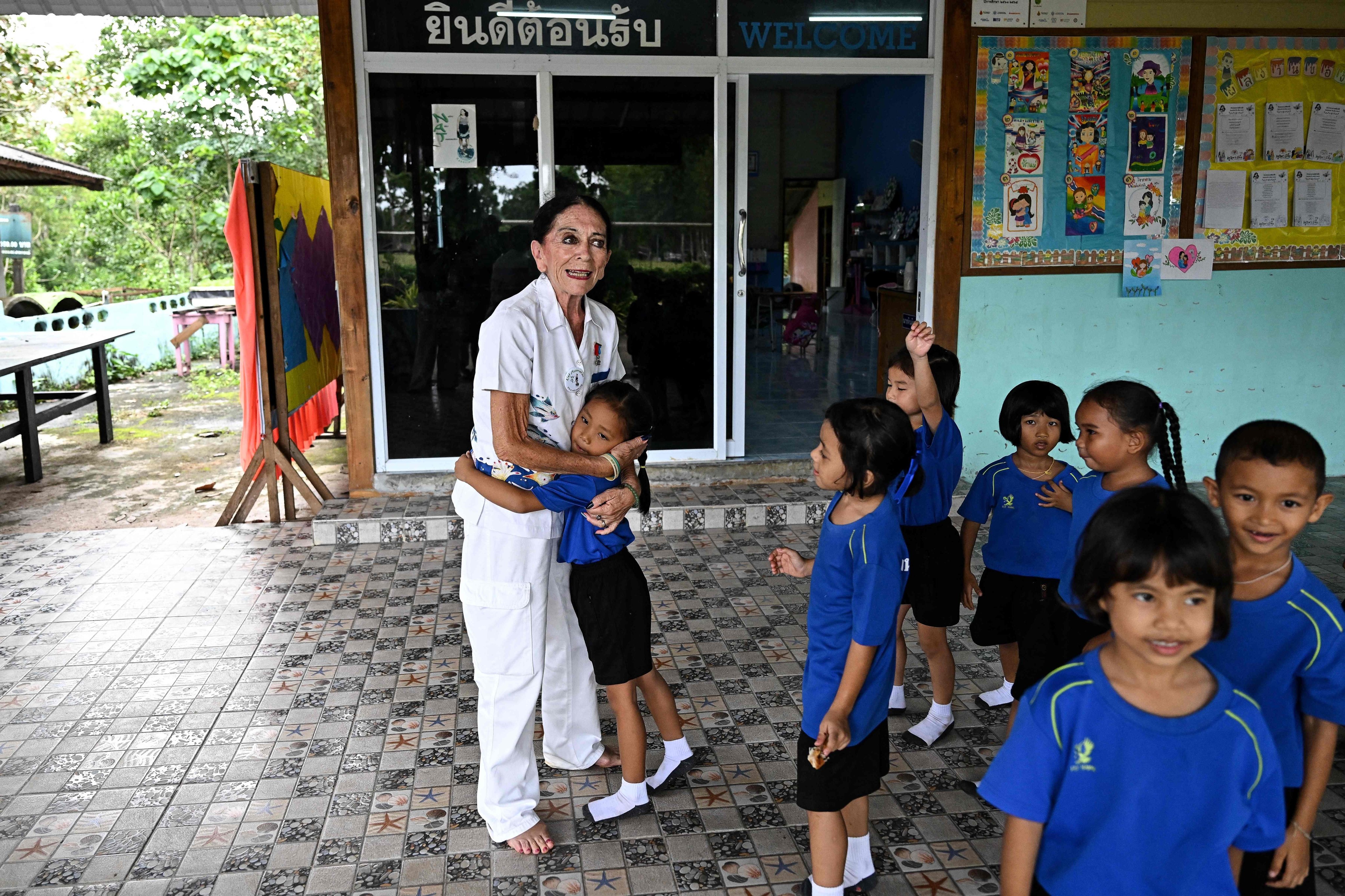 Elisabeth Zana hugs a child at the Bankuankojan school in Krabi. Photo: AFP