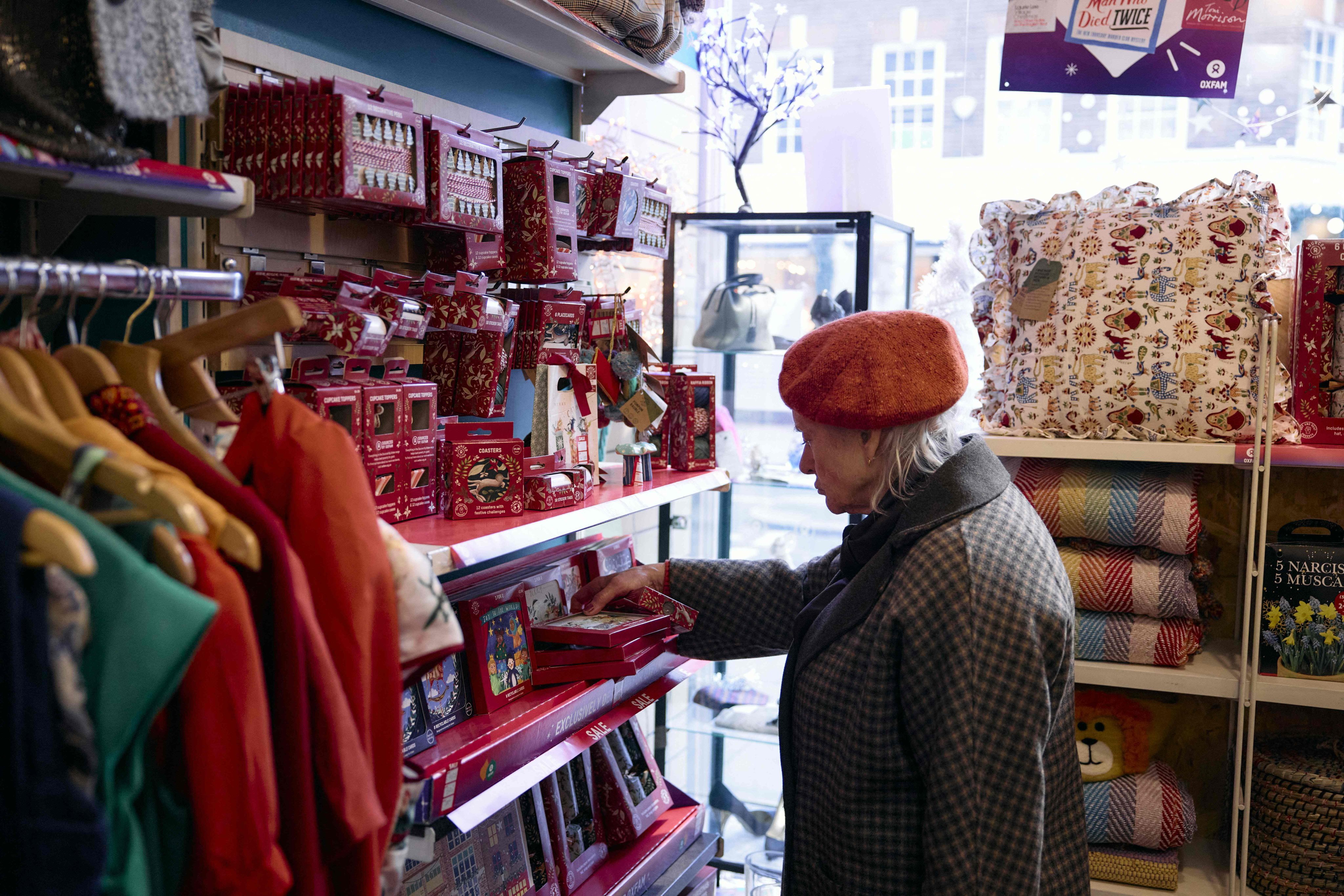 A customer browses second-hand items inside an Oxfam charity shop in London. This Christmas, more people than ever are buying “preloved” gifts from charity shops and online second-hand retailers. Photo: AFP