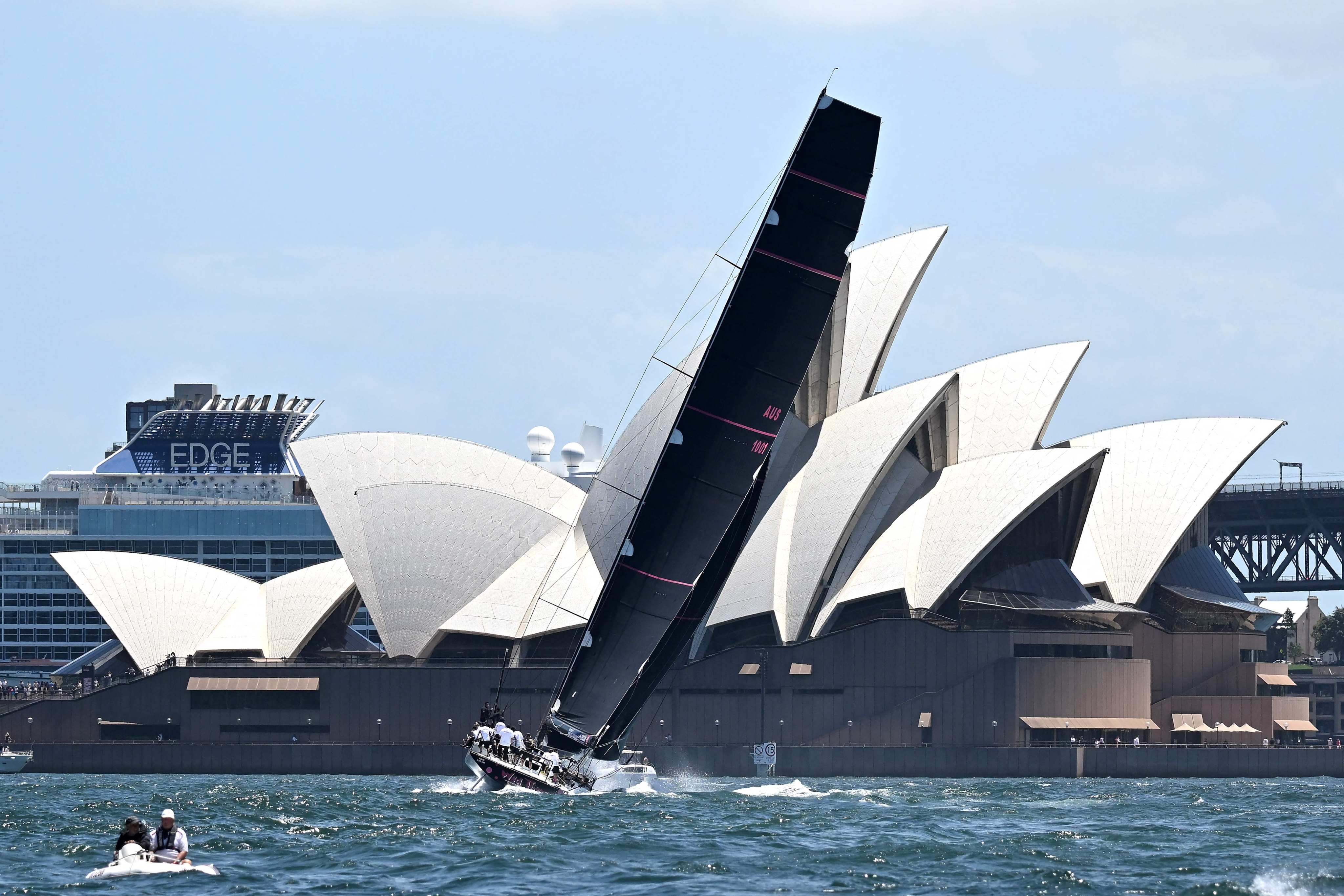 LawConnect crosses the finish line in front of the Opera House during the SOLAS Big Boat Challenge, part of the buildup to the Sydney-Hobart race, in Sydney Harbour on December 10. Photo: AFP