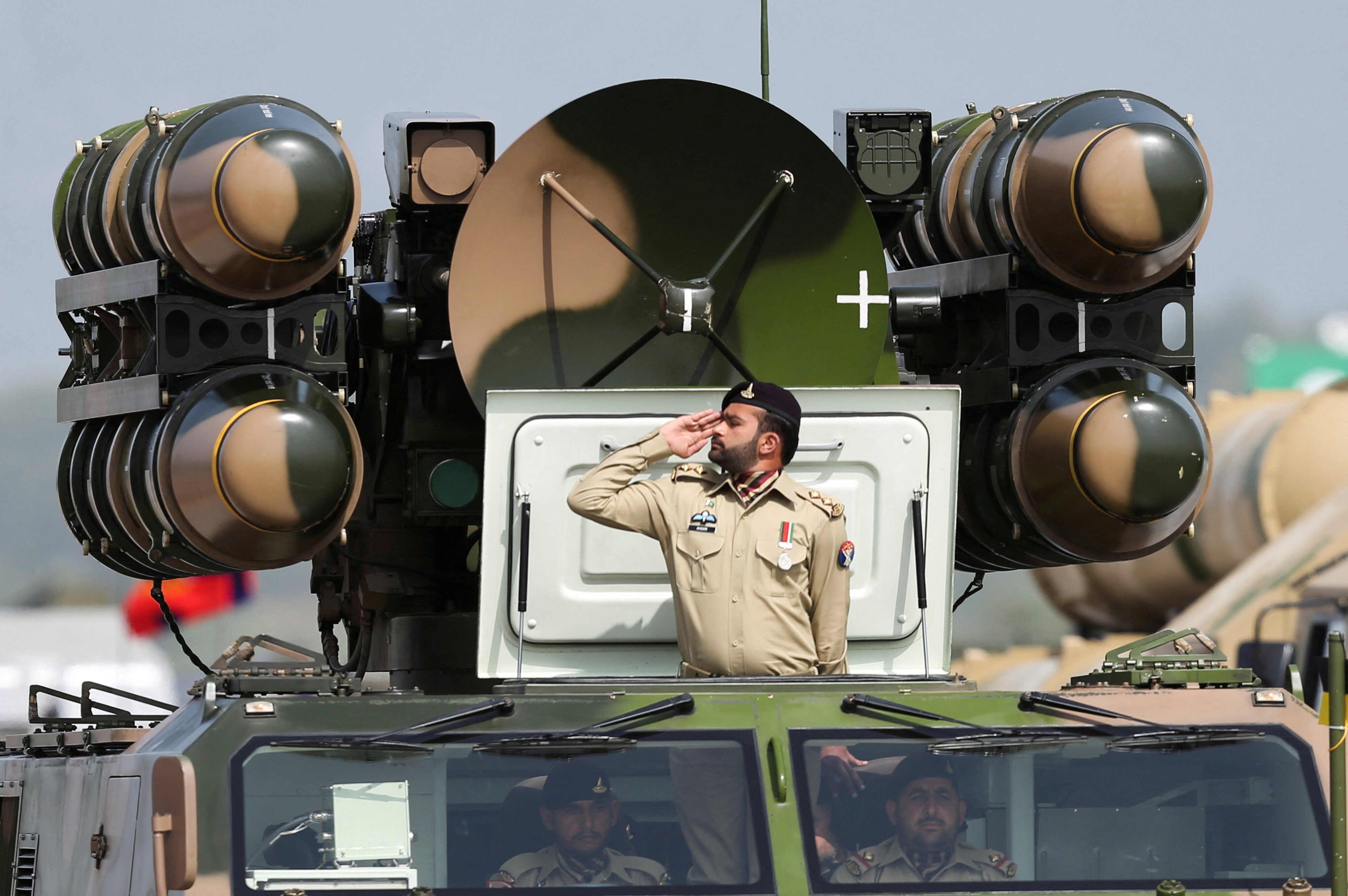 A Pakistani soldier salutes while standing on an air defence missile system during Pakistan Day military parade in Islamabad in 2022. Photo: Reuters