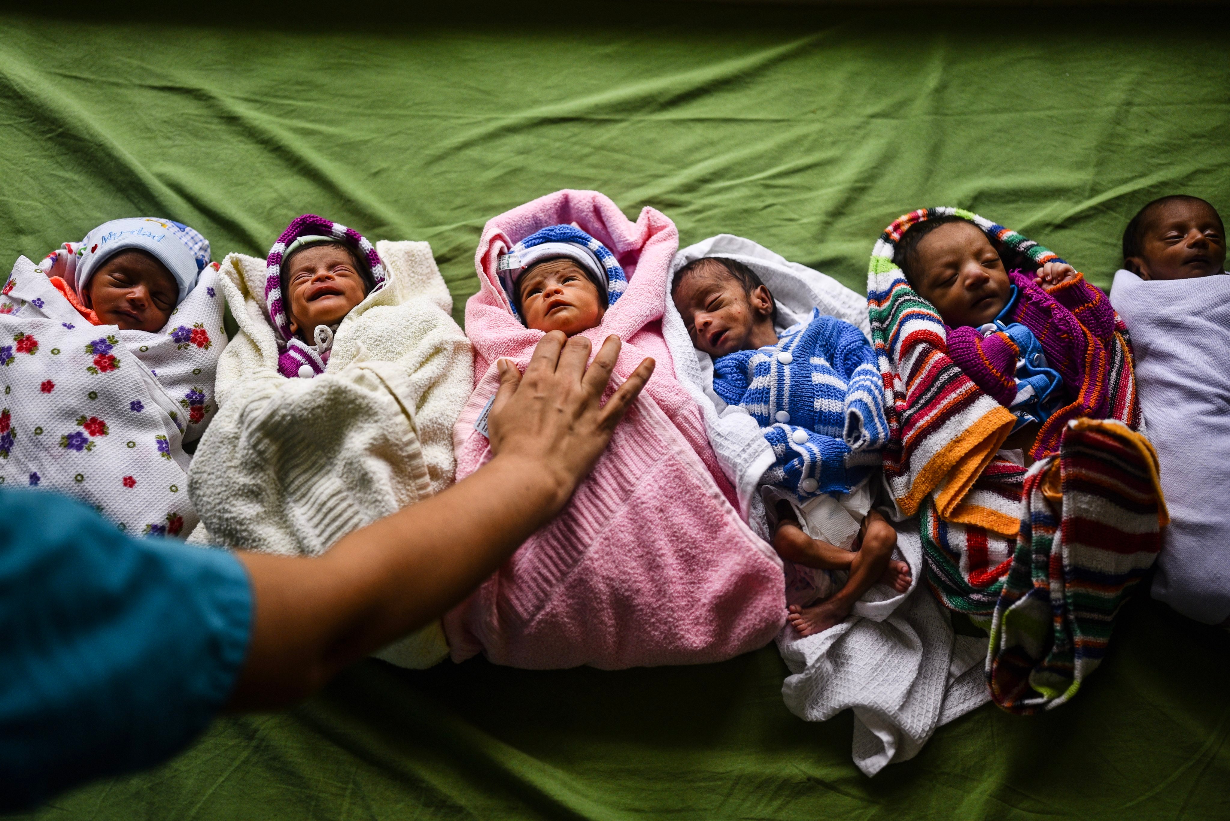 An Indian health worker takes care of newborn babies at a government hospital in Chennai. Photo: EPA-EFE