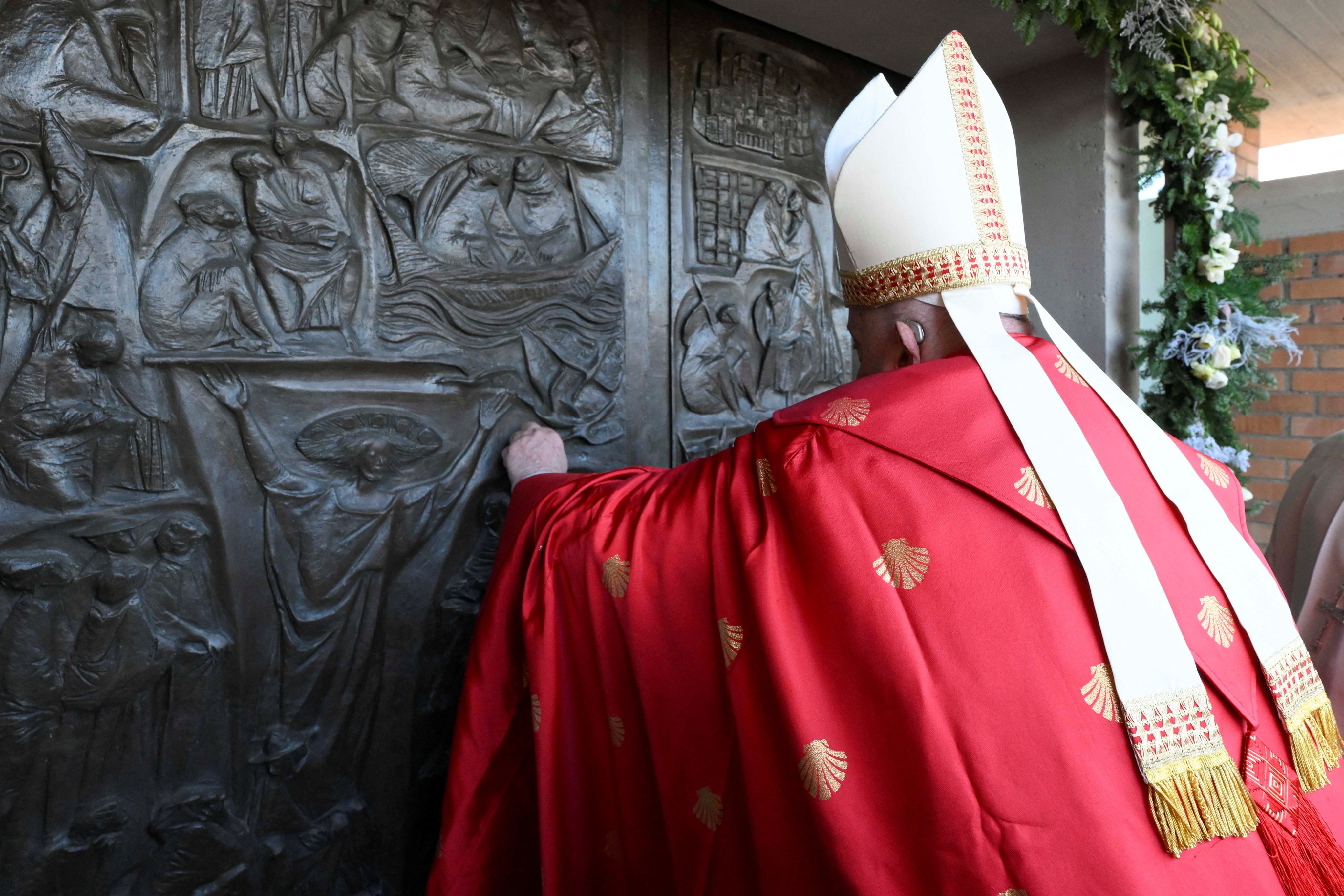 Pope Francis opens a Holy Door, one of only five that will be open during the 2025 Catholic Holy Year, at Rebibbia prison in Rome. Photo: via Reuters