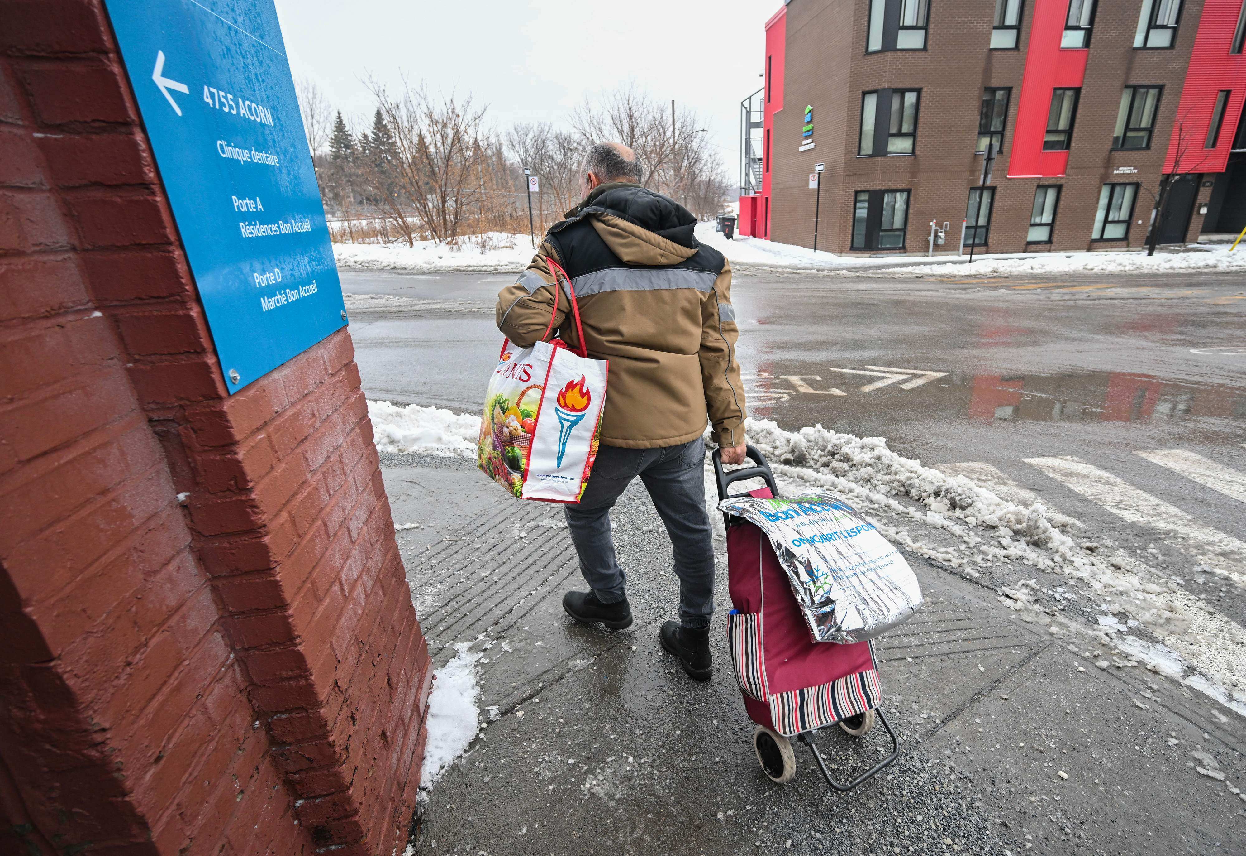 People carry bags of food after visiting the Welcome Hall Mission grocery service for those experiencing food insecurity in Montreal on December 19. A report by food rescue organisation Second Harvest found 21.18 tonnes, or 46.5 per cent of all food produced in Canada, is wasted every year. That ranks Canada among the most wasteful countries in the world. Photo: AFP