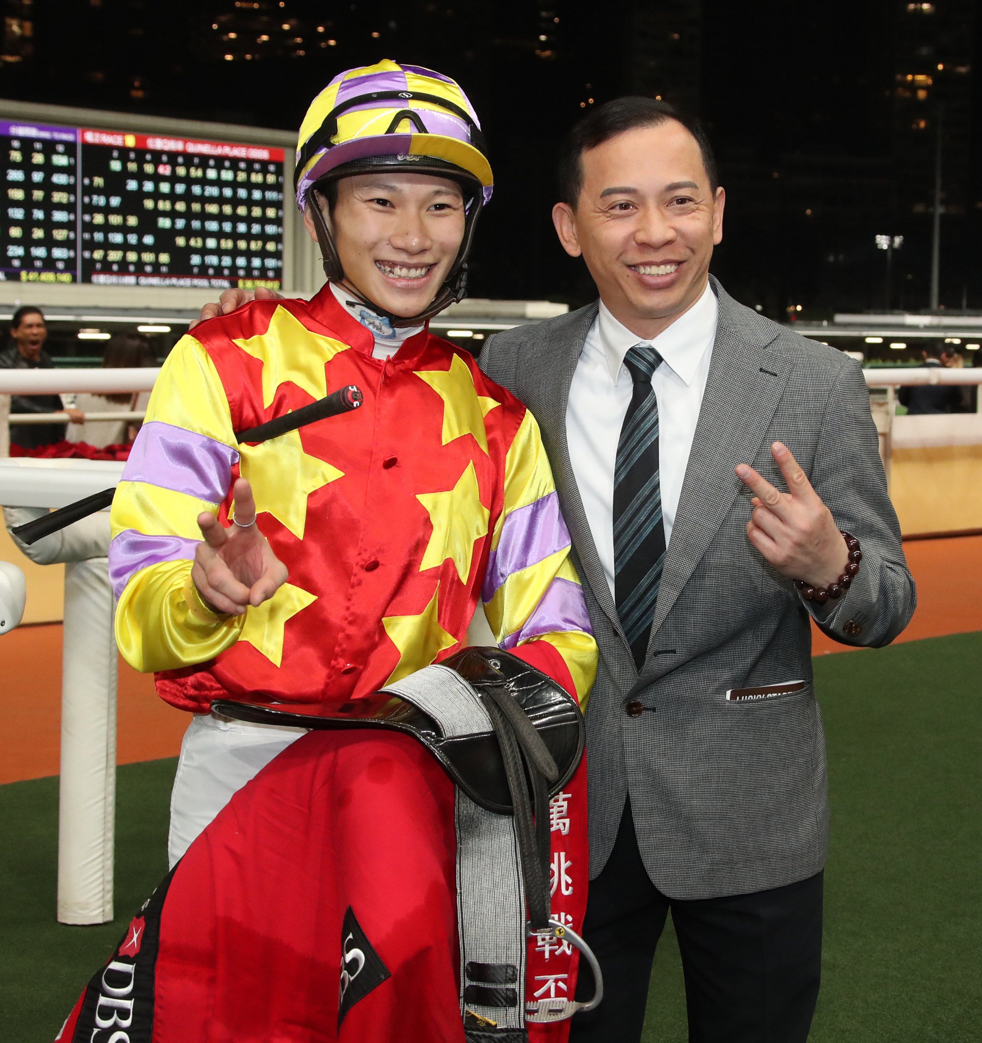 Jockey Jerry Chau and Cody Mo celebrate their doubles at Happy Valley.