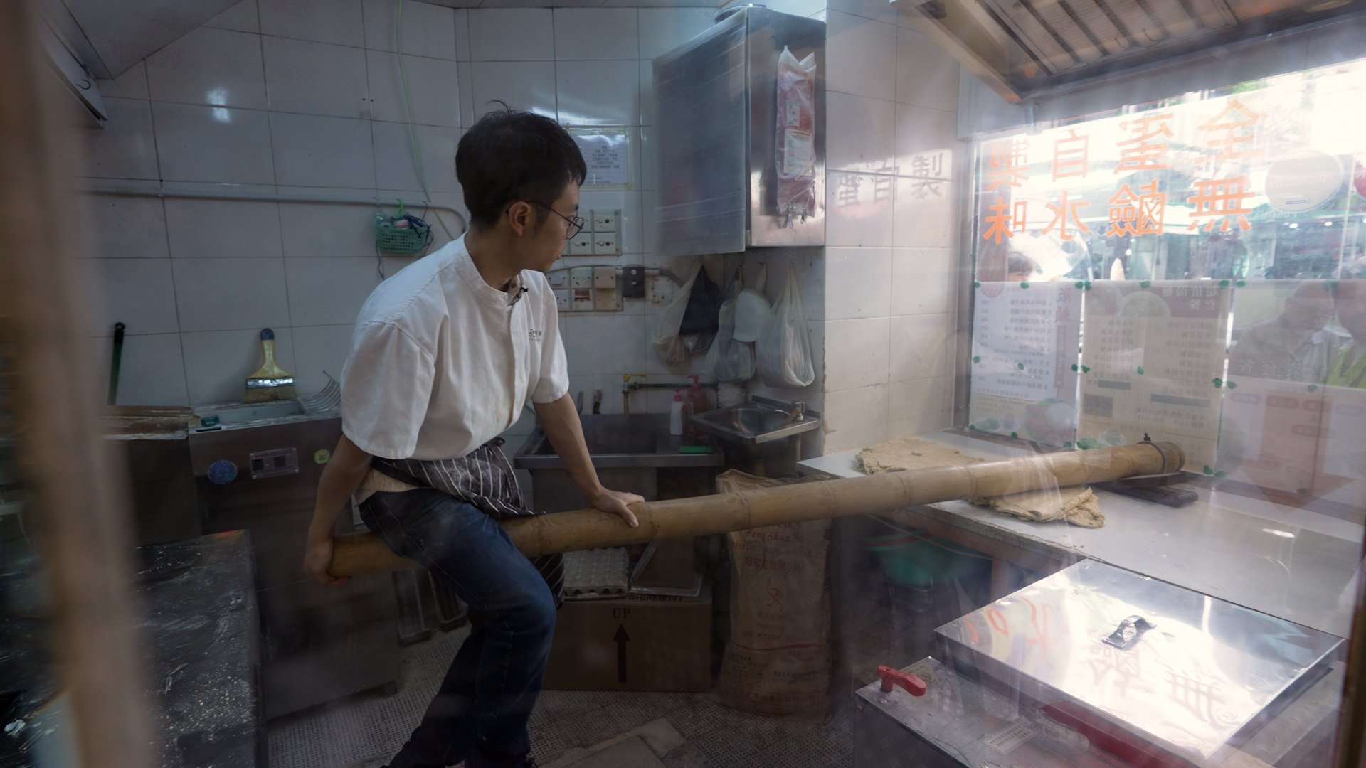 Marco Li Ka-chi of Kwan Kee Bamboo Noodle balancing on a bamboo pole to make noodles. Photo: Llewellyn Cheung