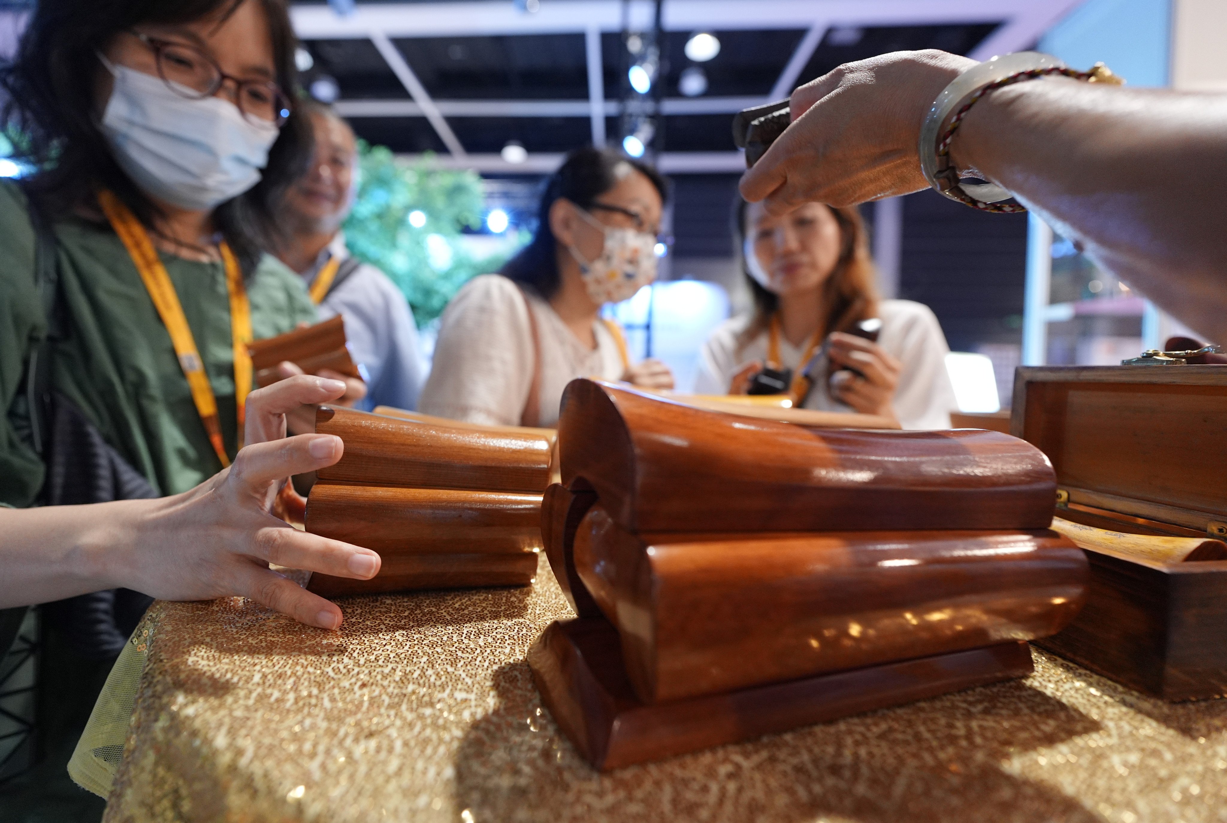 Visitors look at miniature coffins at Asia Funeral and Cemetery Expo and Conference at the Convention and Exhibition Centre in Wan Chai on May 7. Photo: Eugene Lee