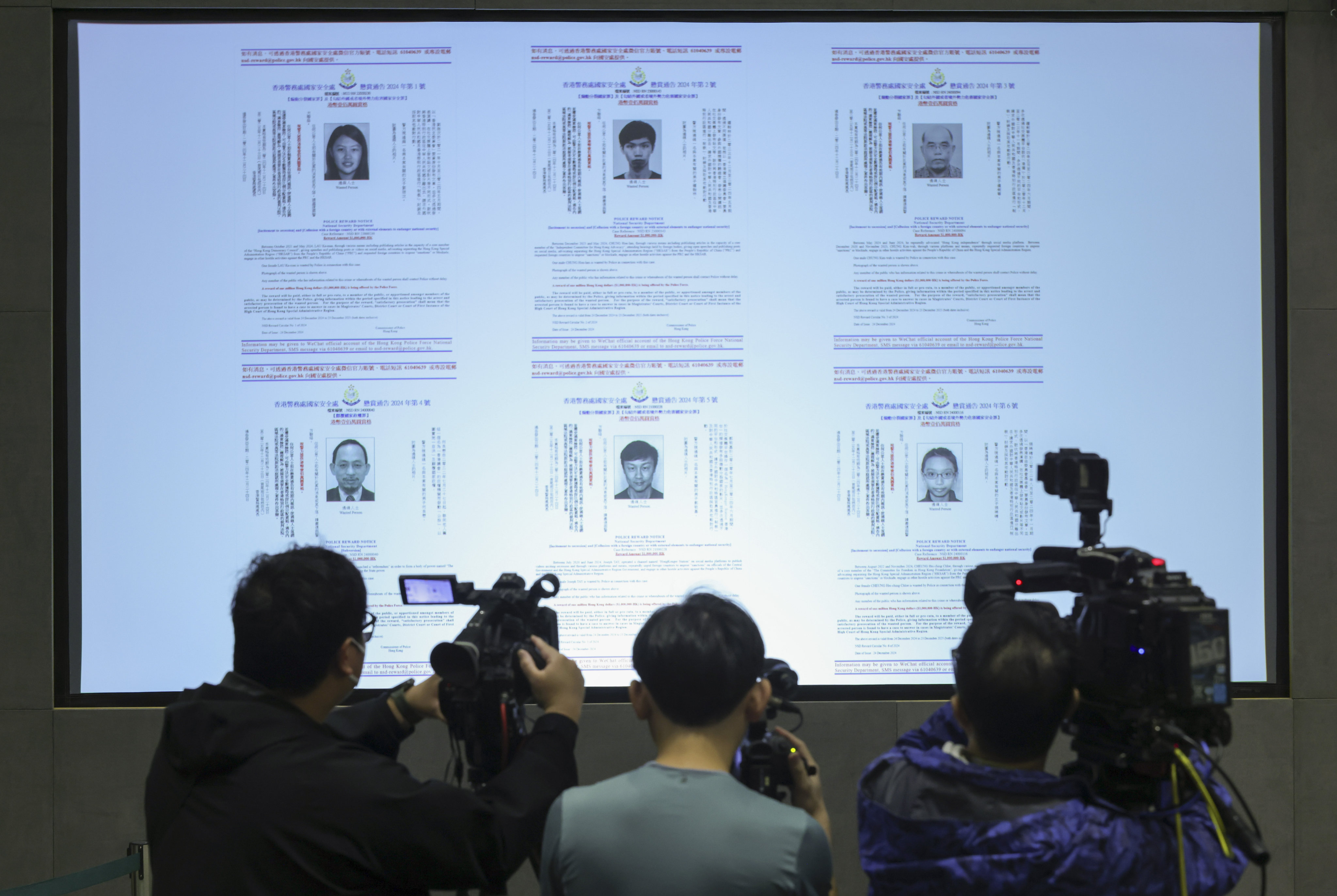 Hong Kong police display posters for six opposition figures while announcing bounties of HK$1 million. Photo: SCMP / Jelly Tse
