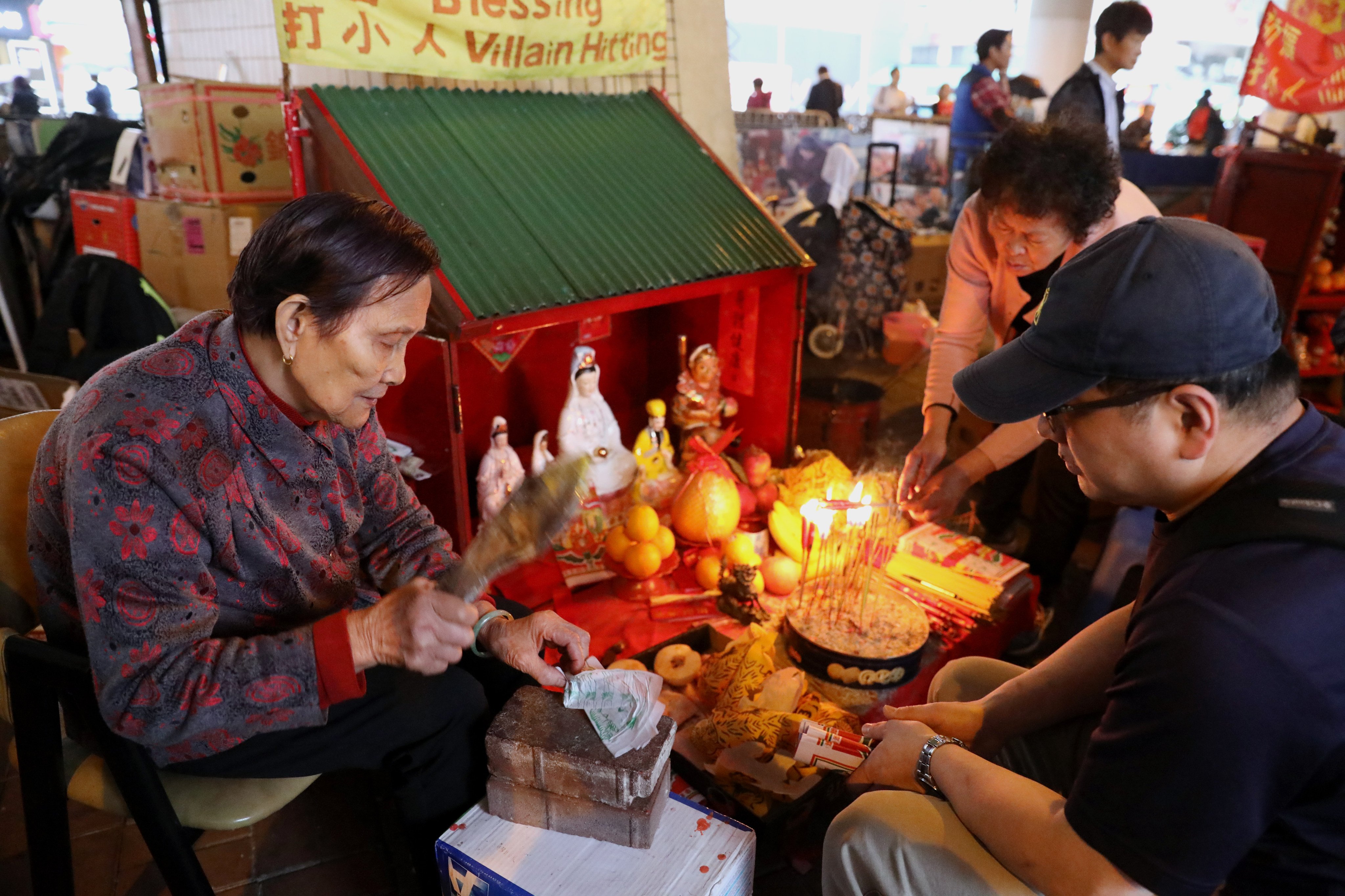 One of the “villain hitters” who operate under a flyover in Hong Kong performs a ritual. They practise a form of witchcraft, belief in which remains strong in the modern age in many parts of the world, as it has for thousands of years. Photo: Dickson Lee