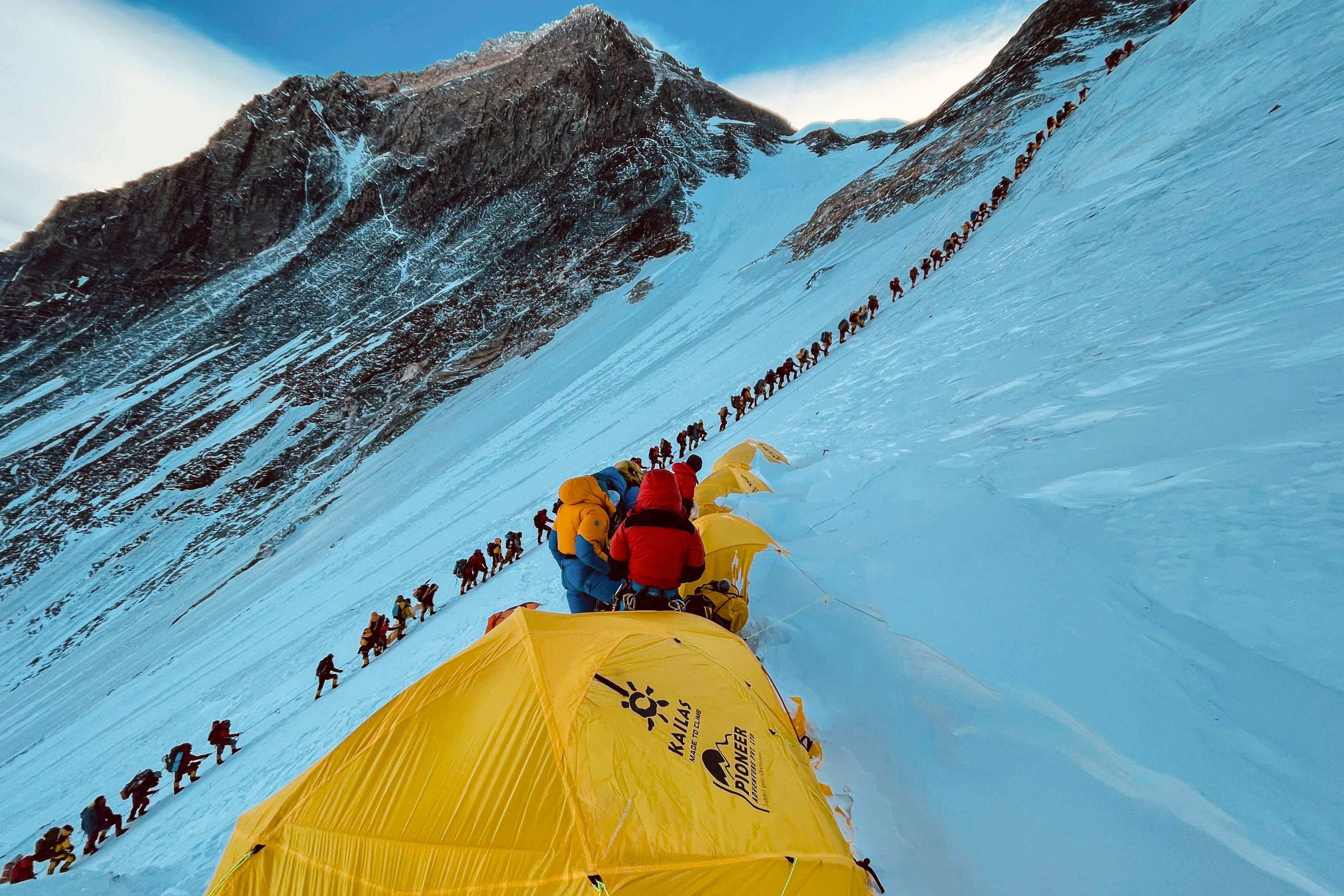 Mountaineers climb a slope during their ascent of Mount Everest in Nepal in 2021. A story about overcrowding on peaks like this one was one of the top five travel stories of the year. Photo: AFP