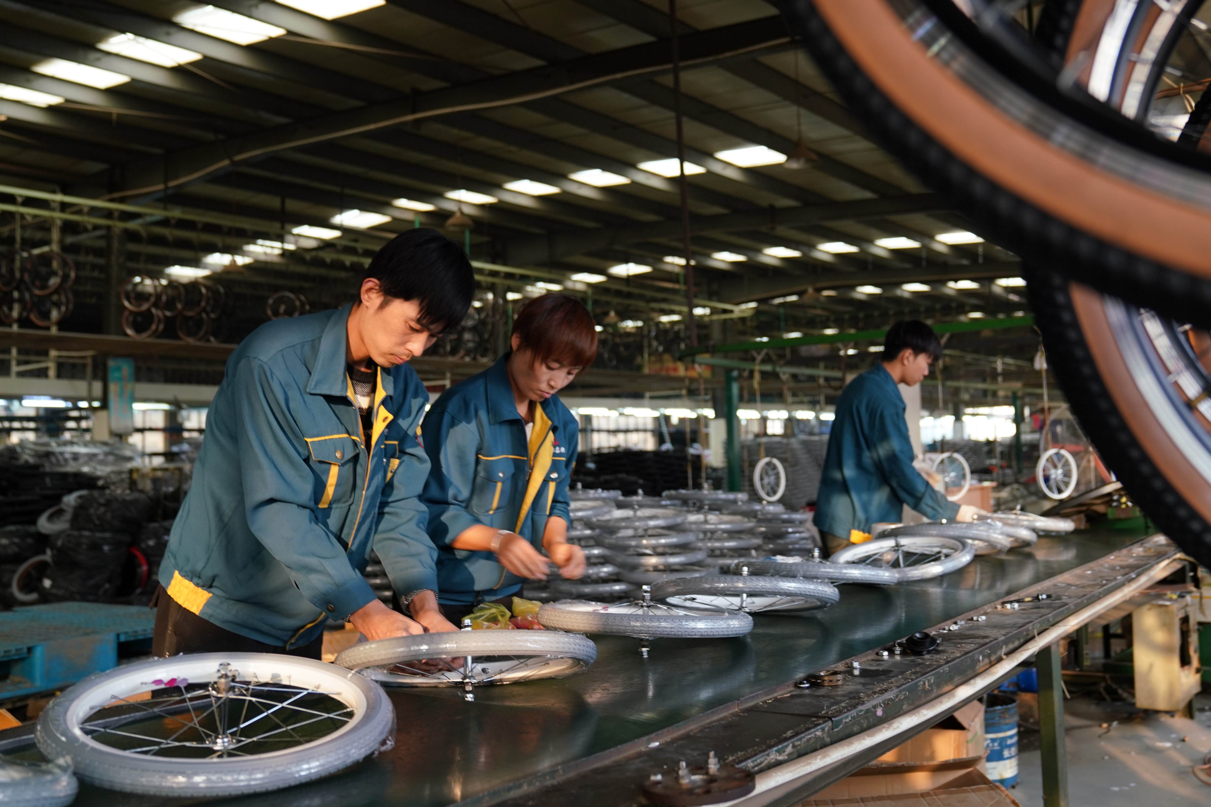 Workers make wheels at a bicycle factory in Pingxiang county, Hebei province, in October. Photo: Xinhua