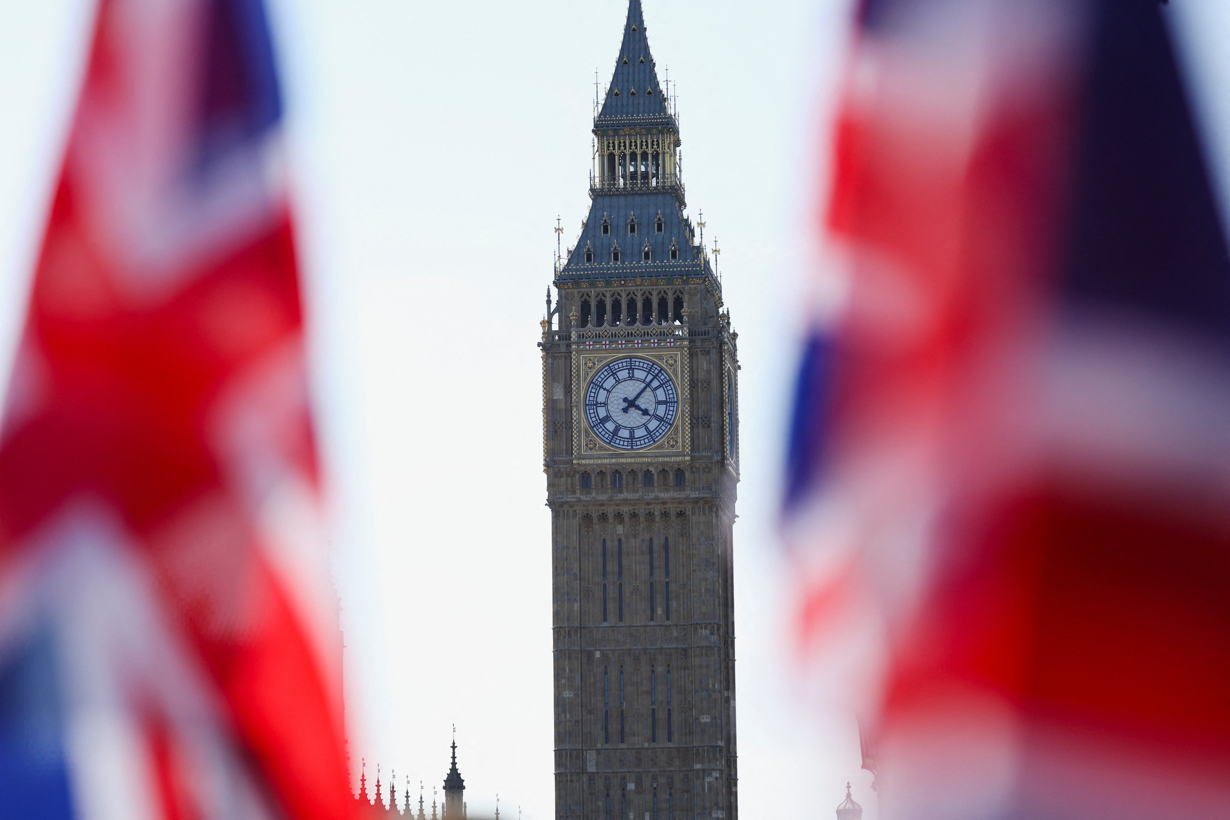 Union Jack flags flutter in the wind near Big Ben at Parliament Square in London. Photo: Reuters