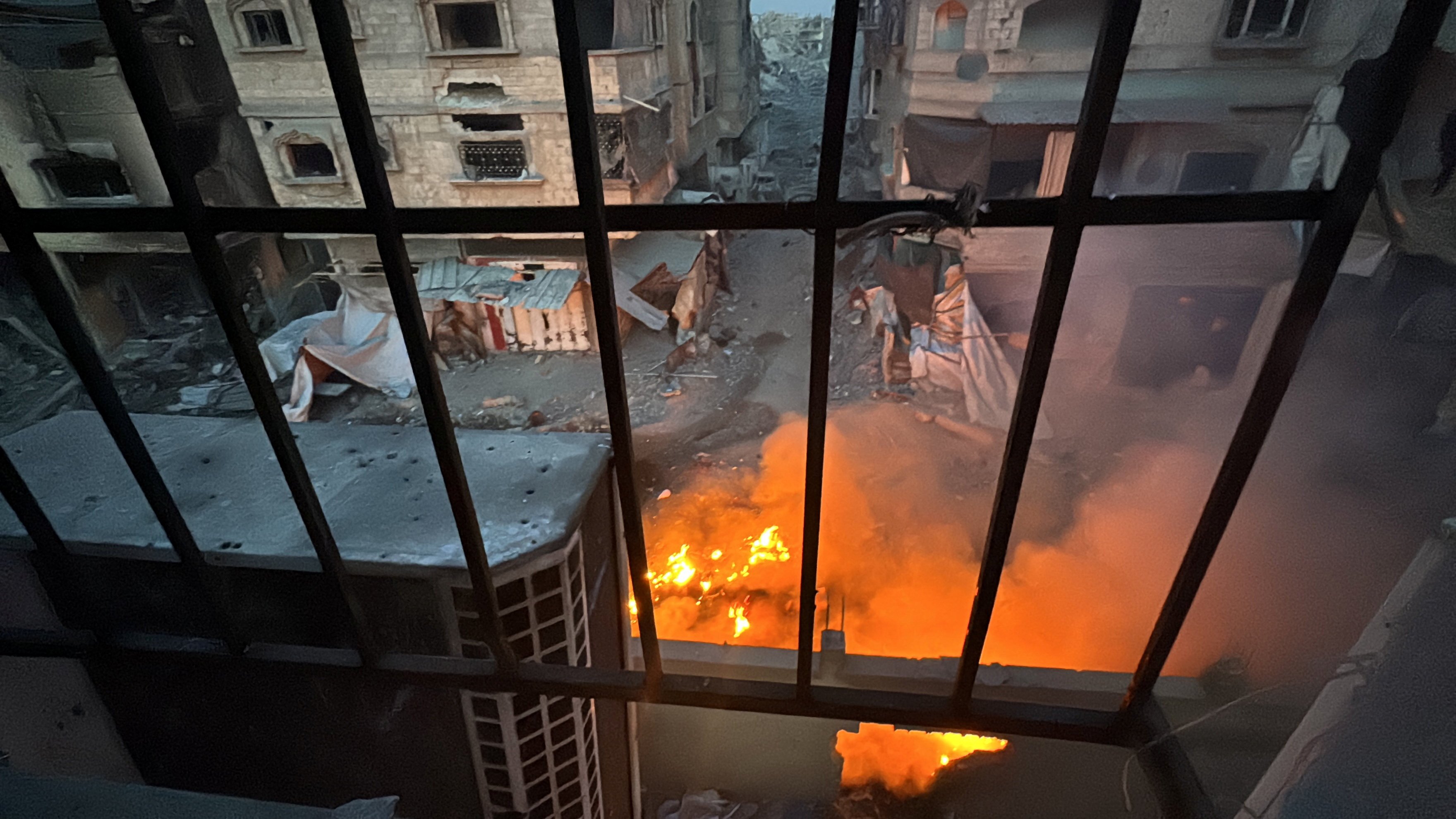 A fire seen through a window from Kamal Adwan Hospital in northern Gaza. On Friday, Gaza’s health ministry said Israeli troops forcibly removed staff and patients from the hospital. Photo: Reuters