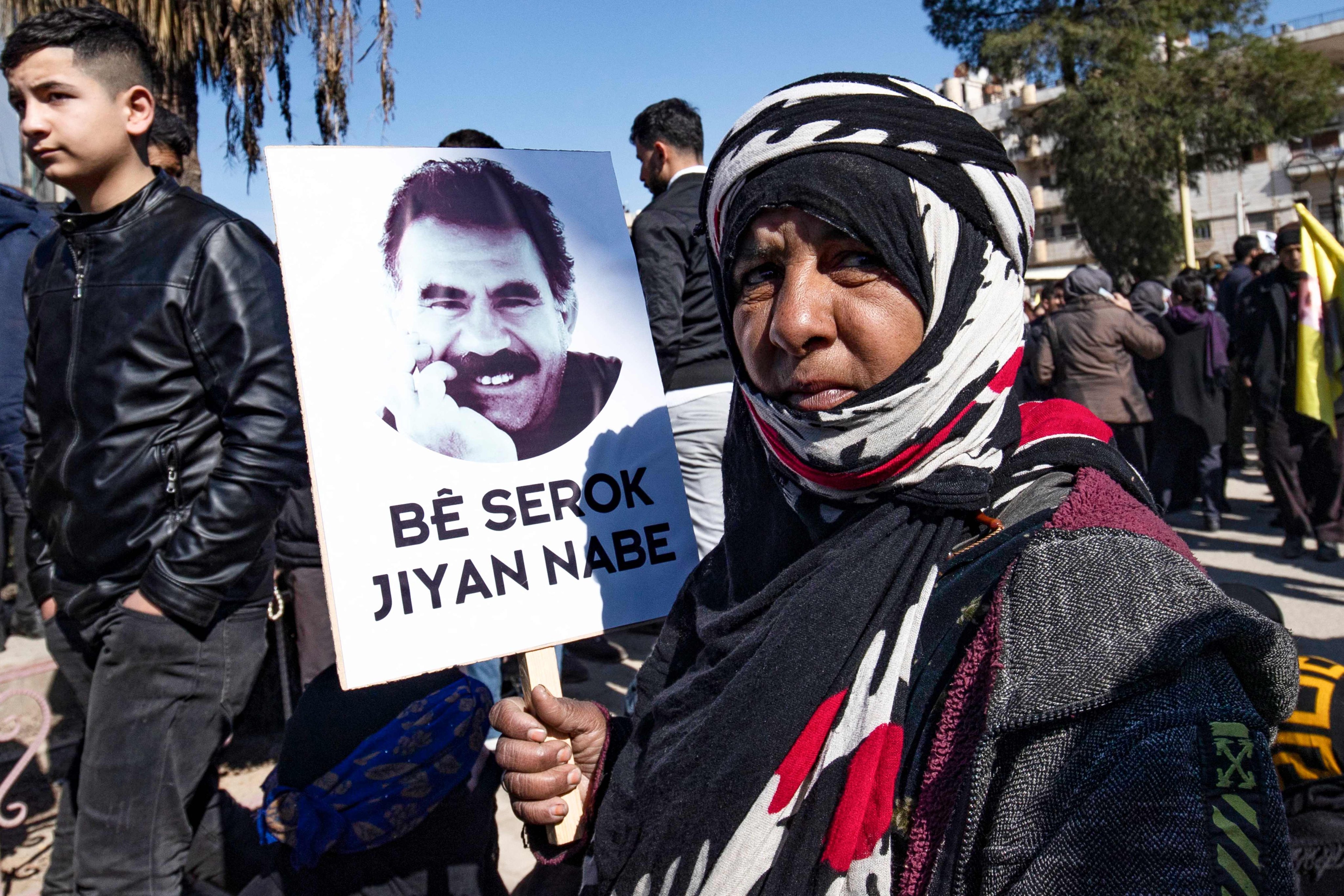 (FILES) A protester holds up a placard bearing a portrait of Abdullah Ocalan, the leader of the Kurdistan Worker’s Party (PKK) – jailed in Turkey since 1999 – during a demonstration caling for his release in the Kurdish-majority city of Qamishli in northeastern Syria on February 15, 2023. Photo: AFP