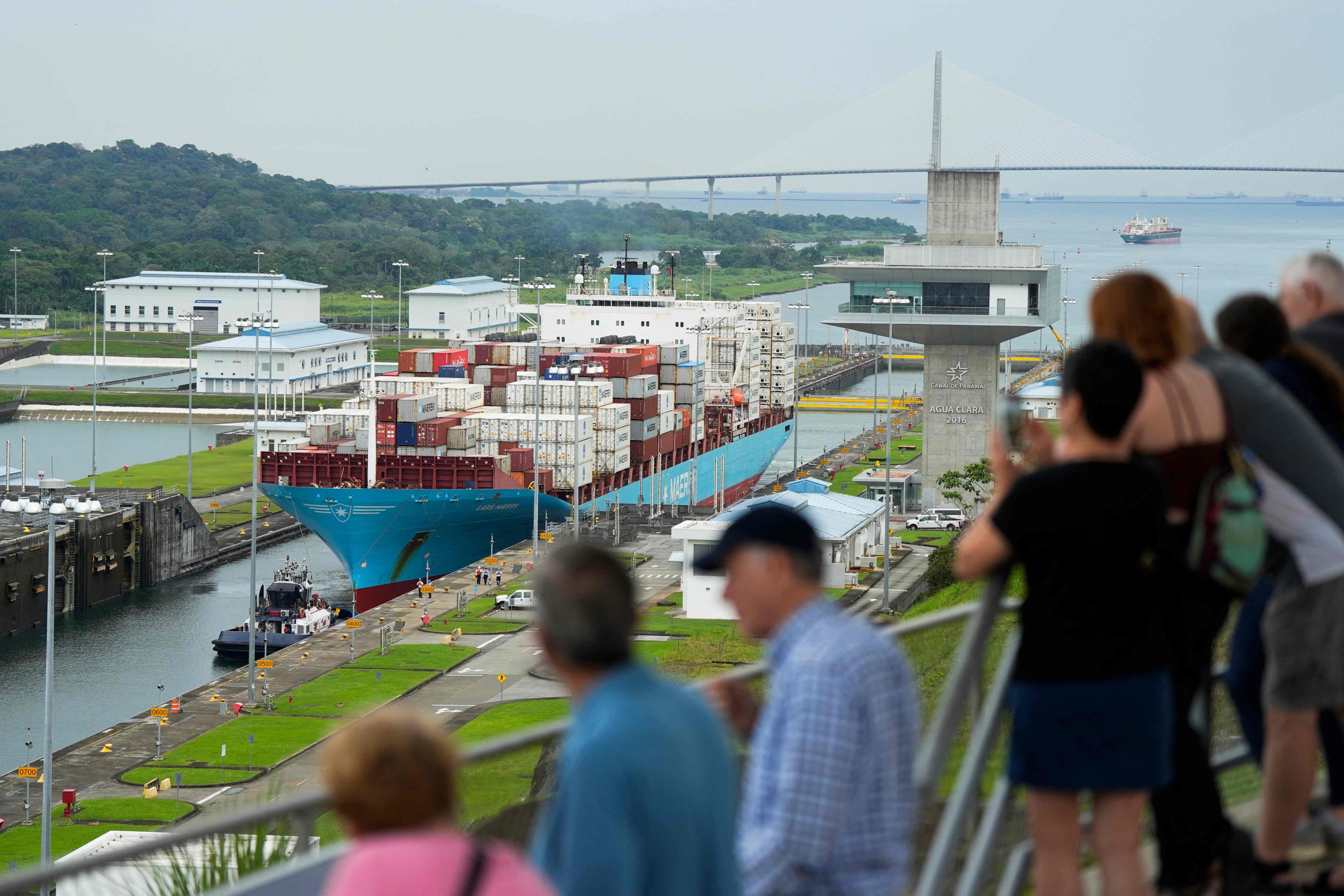 Tourists watch a cargo ship sailing through the Agua Clara Locks of the Panama Canal. Photo: AFP