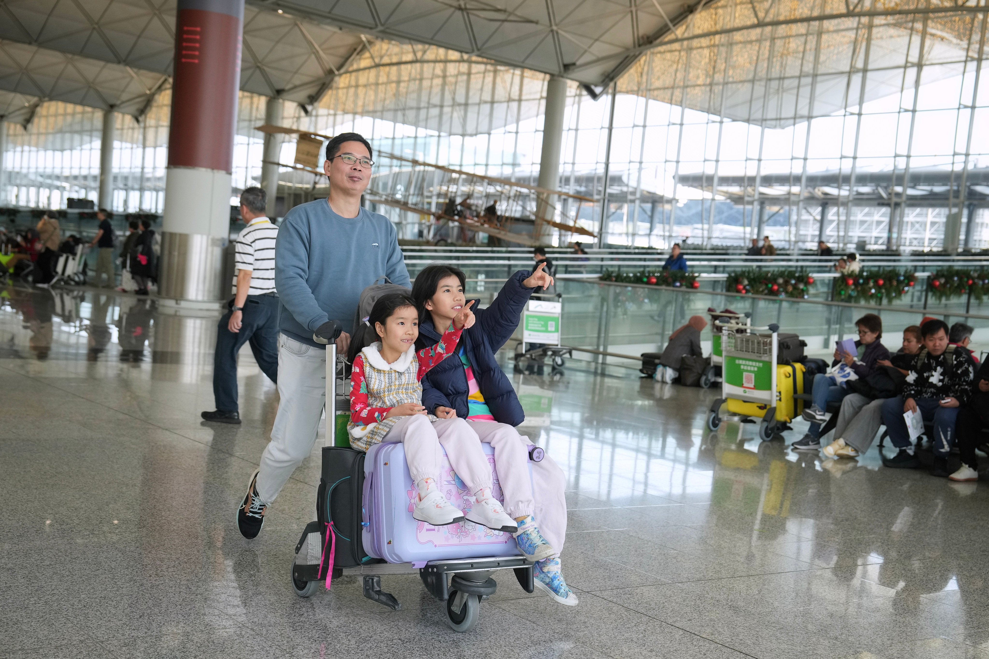 Travellers pass through Hong Kong airport’s departure hall in the run-up to Christmas. Photo: Elson Li