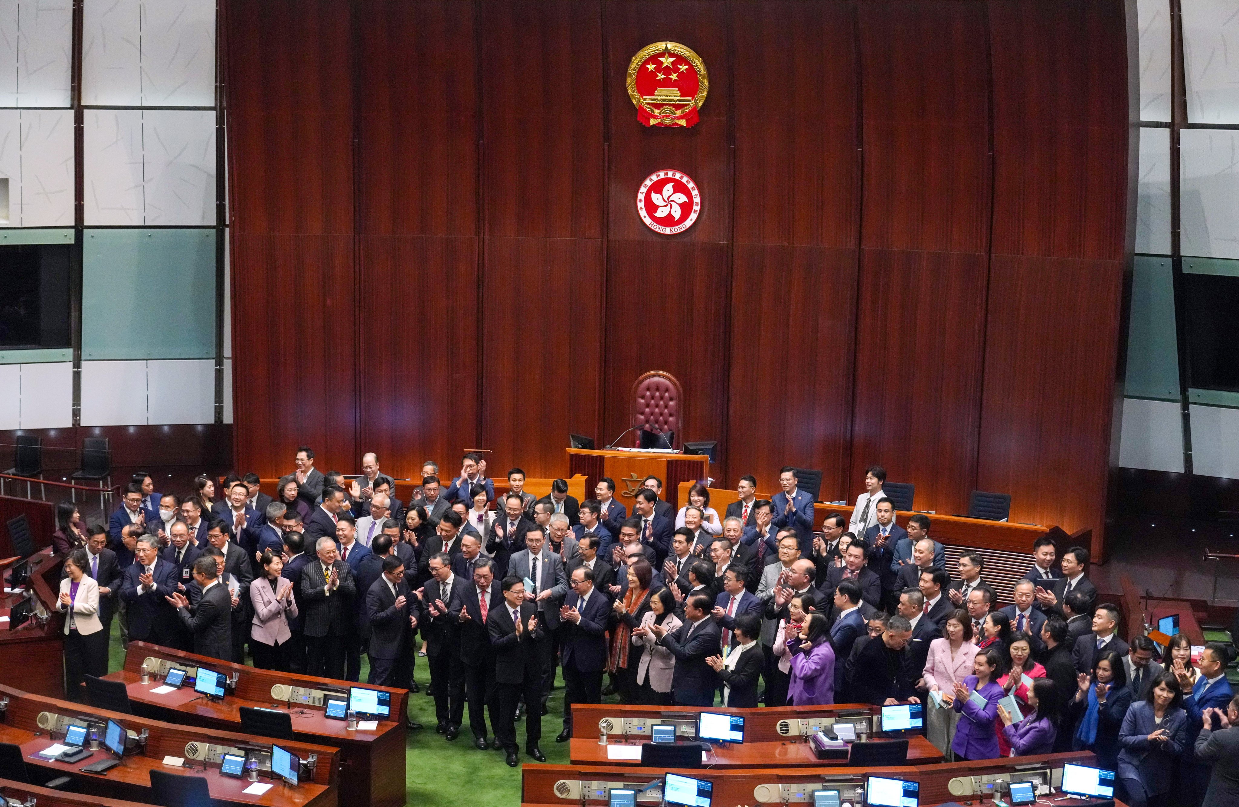 Hong Kong leader John Lee and lawmakers gather for pictures after the vote on domestic national security legislation at the Legislative Council. Photo: Sam Tsang