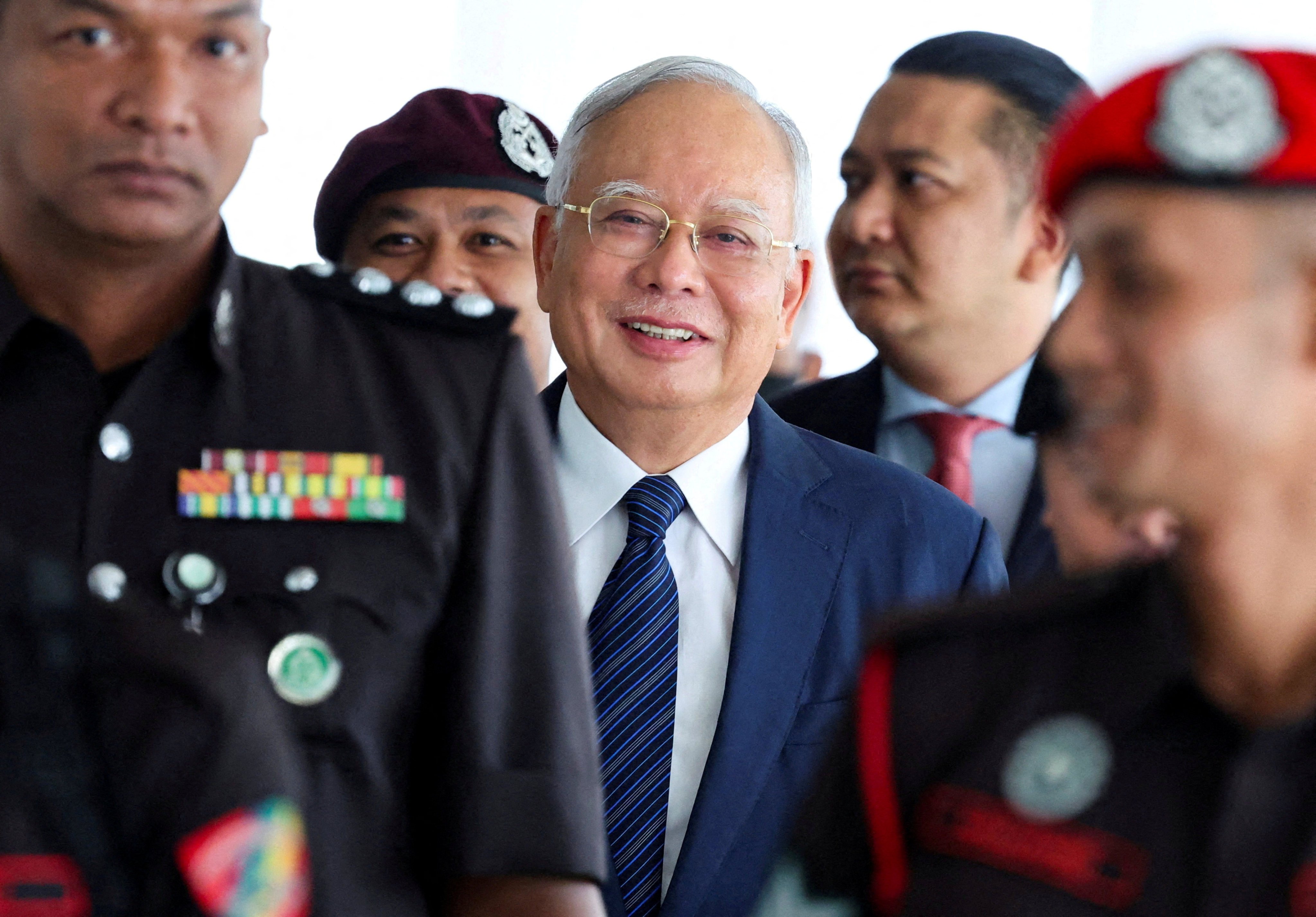 Former Malaysian prime minister Najib Razak being escorted during a break in court proceedings in Kuala Lumpur in April. Photo: Reuters