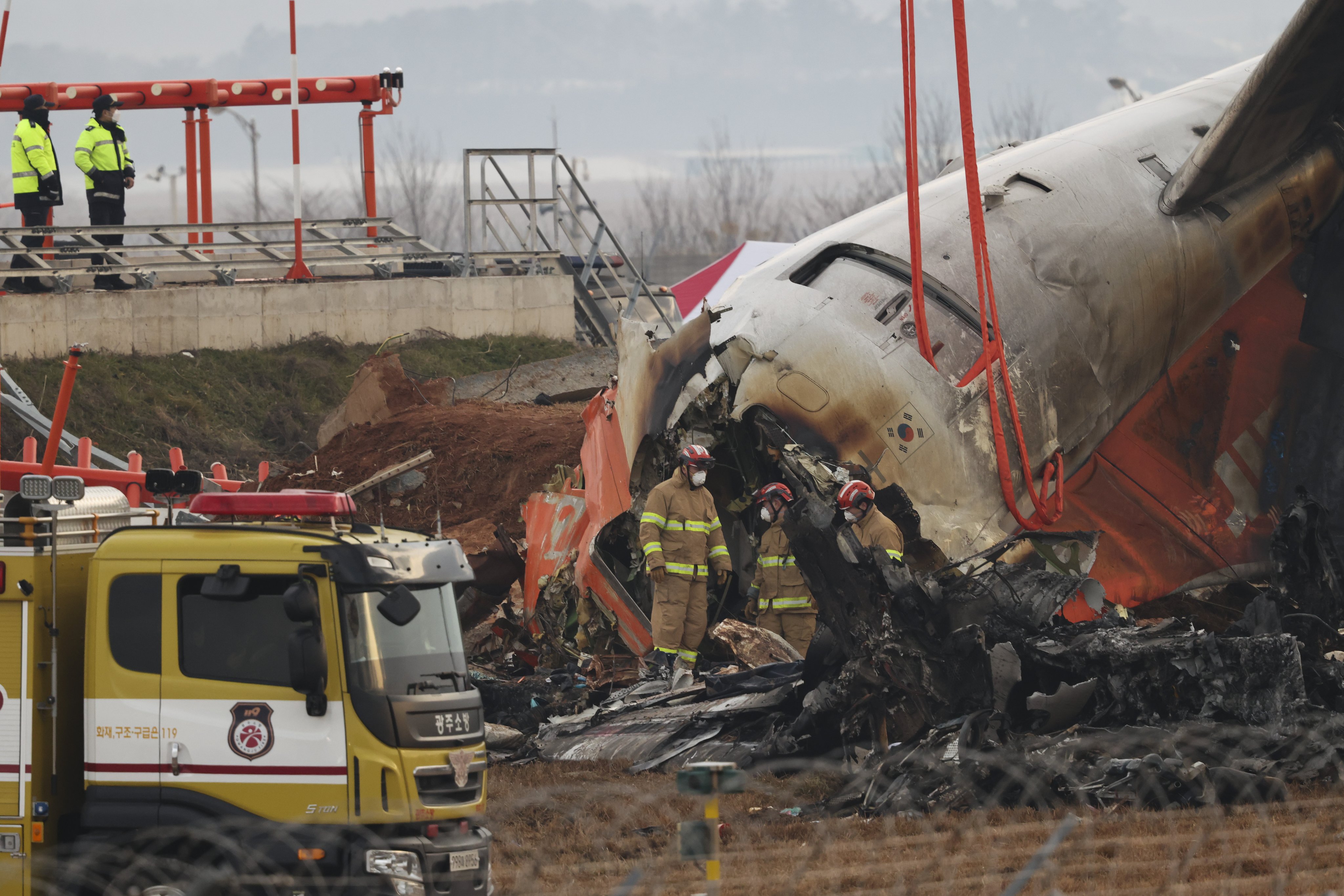 Firefighters conduct search operations at the wreckage site of the Jeju Air aircraft at Muan International Airport. Photo: EPA-EFE