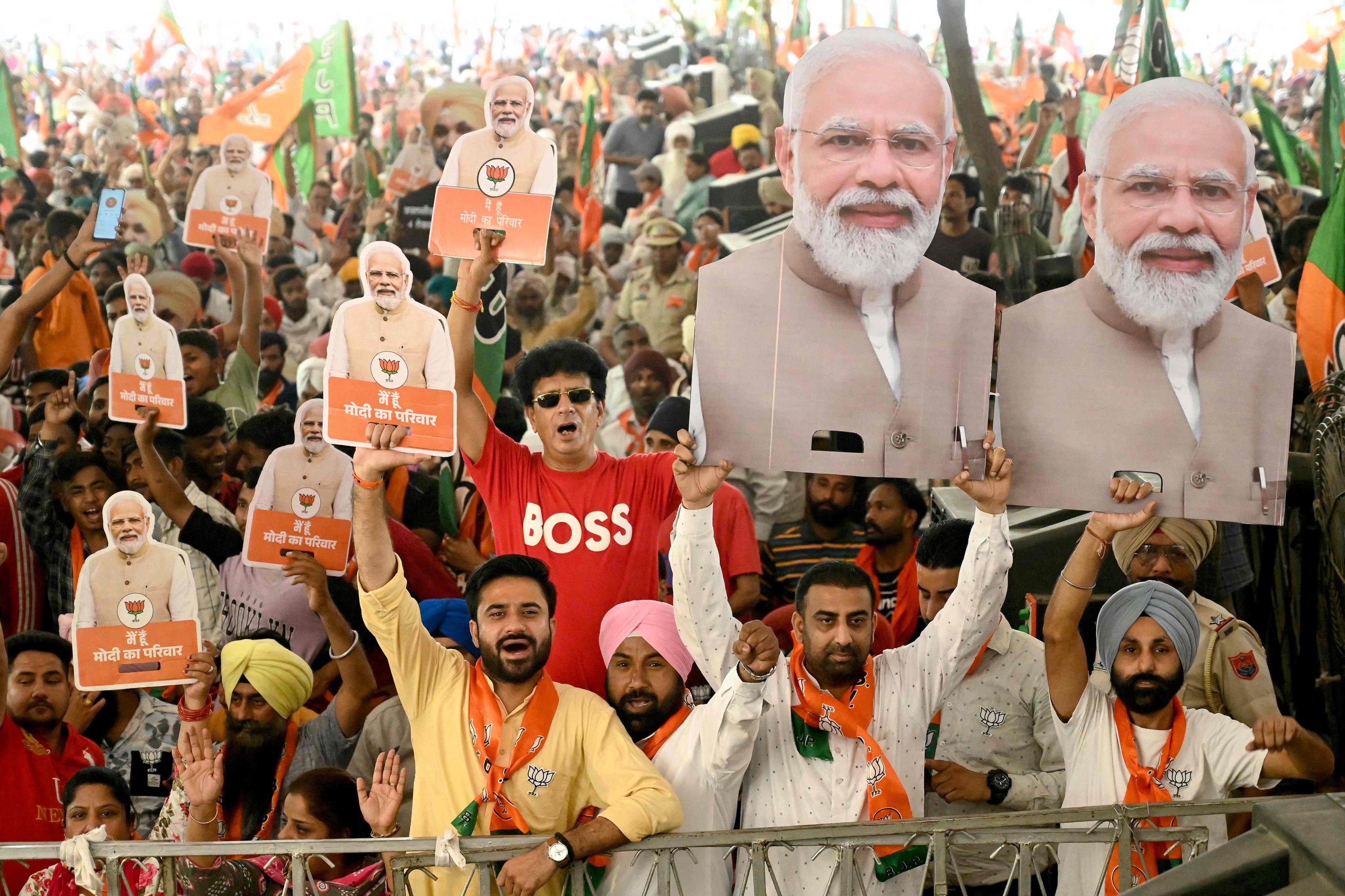 Supporters of the ruling Bharatiya Janta Party hold cut-outs of India’s Prime Minister and their leader Narendra Modi at an election rally in Amritsar in May. Photo: AFP