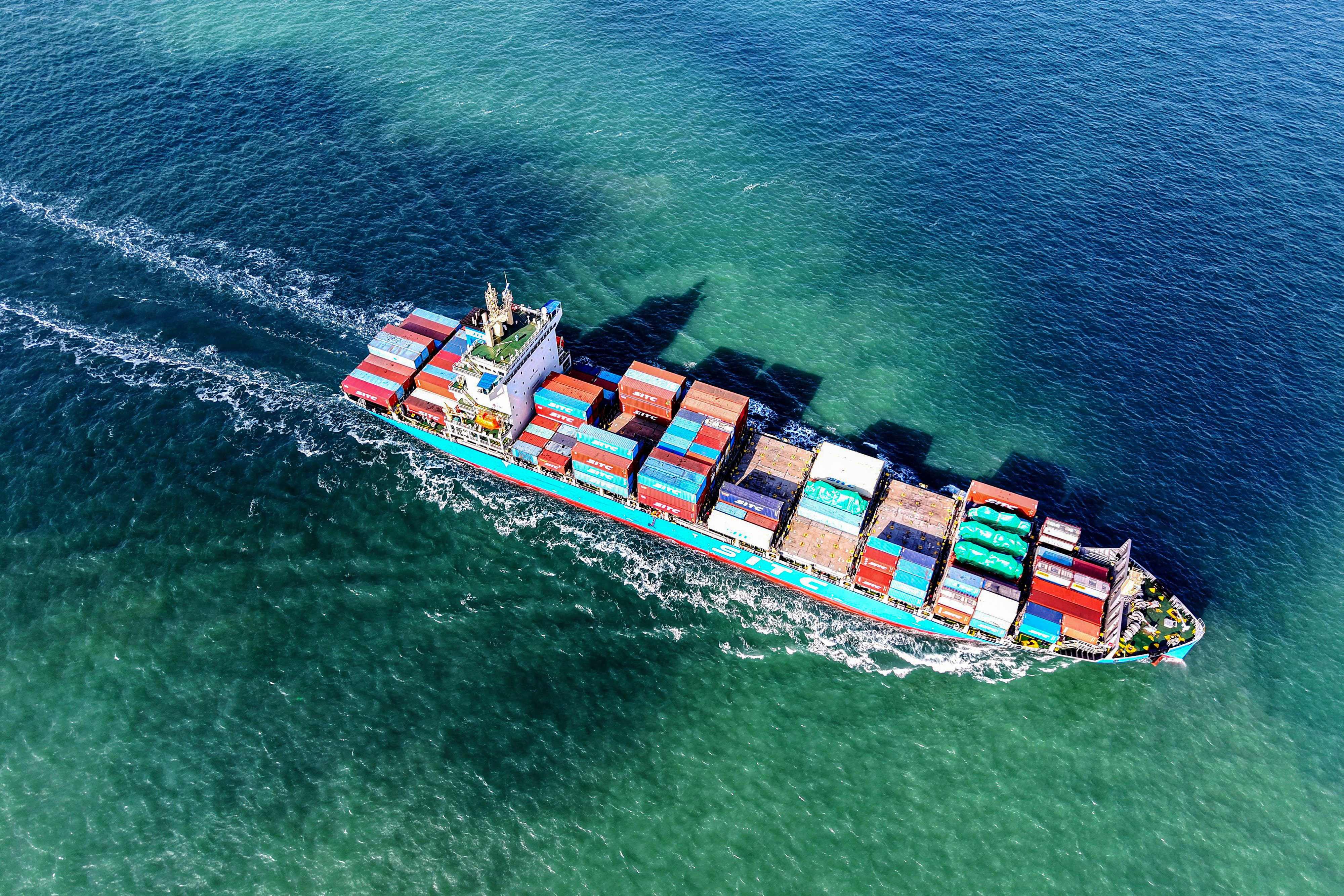 A cargo ship loaded with containers sails from Qingdao port in in eastern China’s Shandong province, on December 26. Photo: AFP