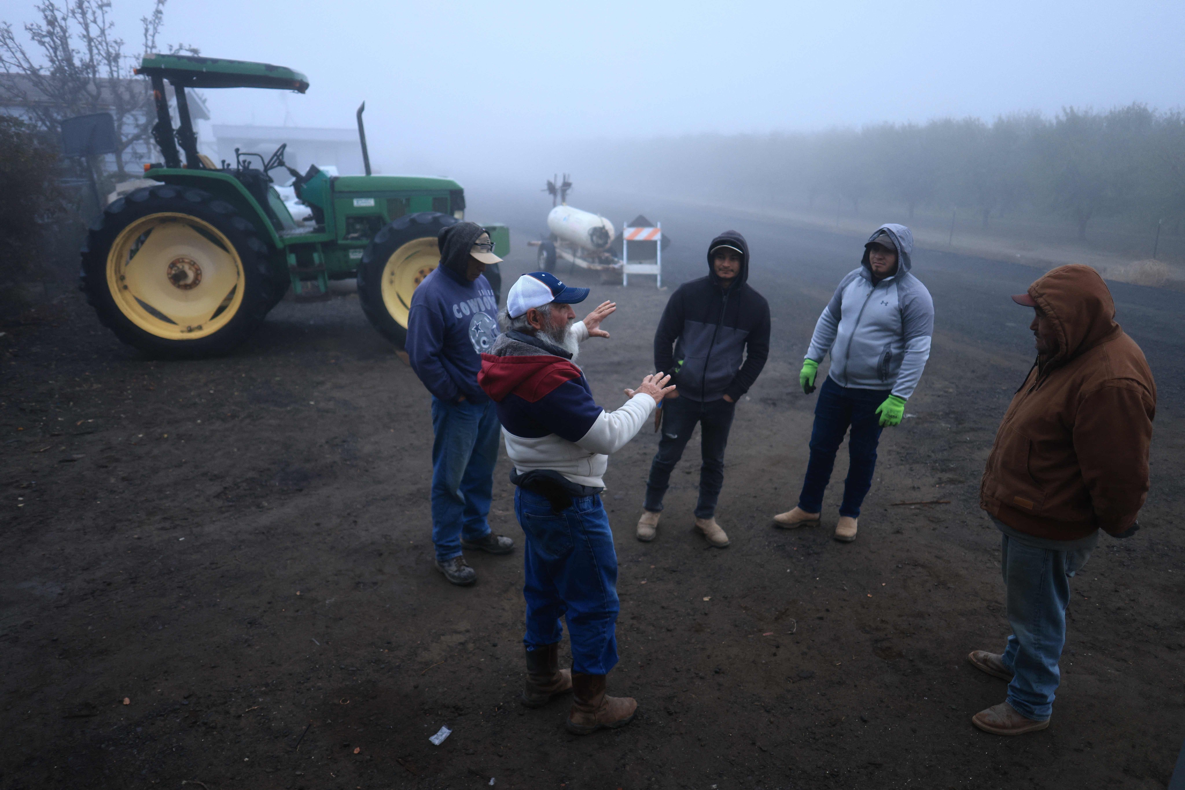 A supervisor talks to workers, some undocumented, at the start of a workday at Del Bosque Farms in Firebaugh, California. Photo: AFP