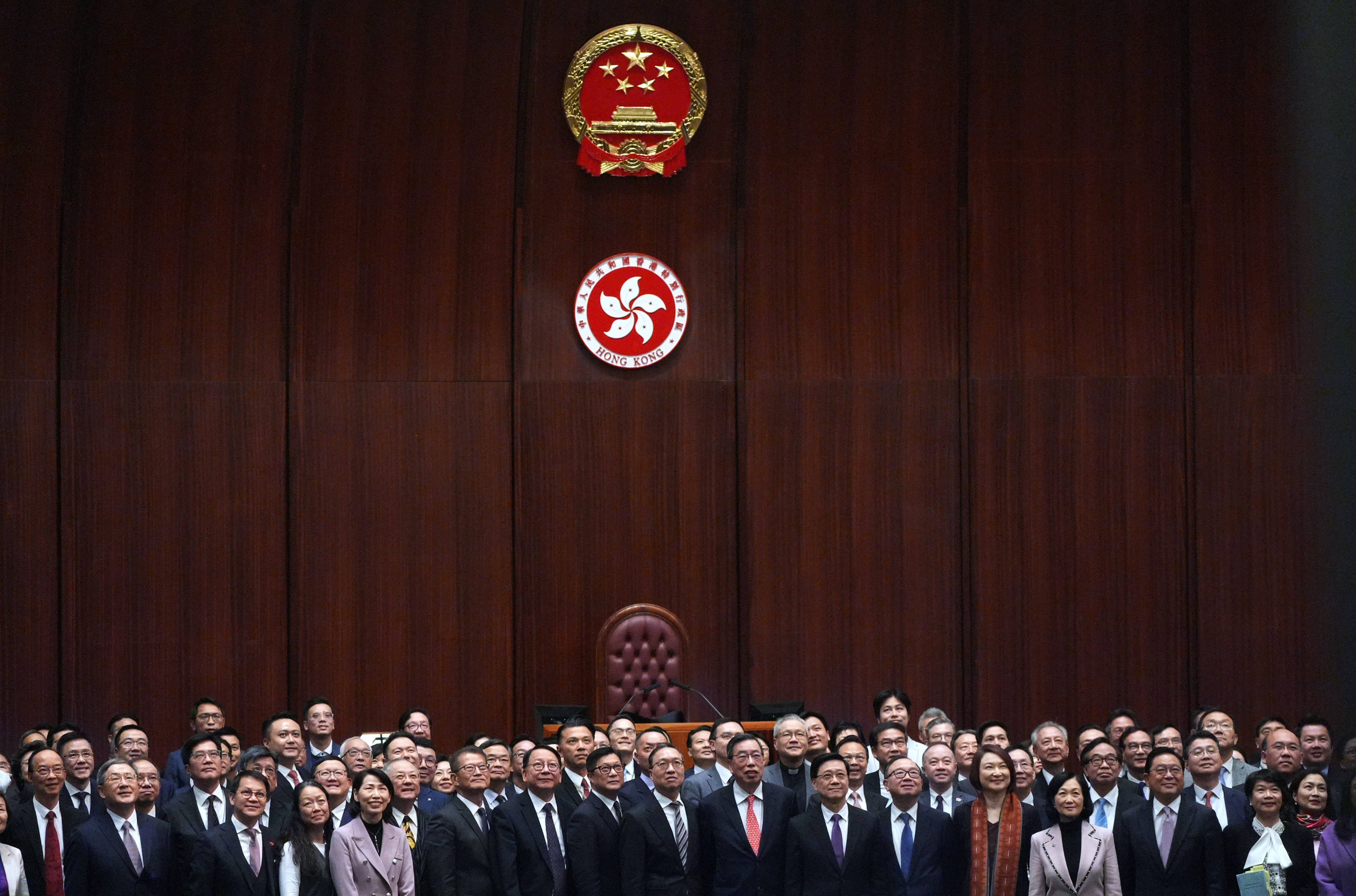 Chief Executive John Lee Ka-chiu and Legco members pose for pictures after the passing of the
Safeguarding National Security Ordinance. Photo: Eugene Lee