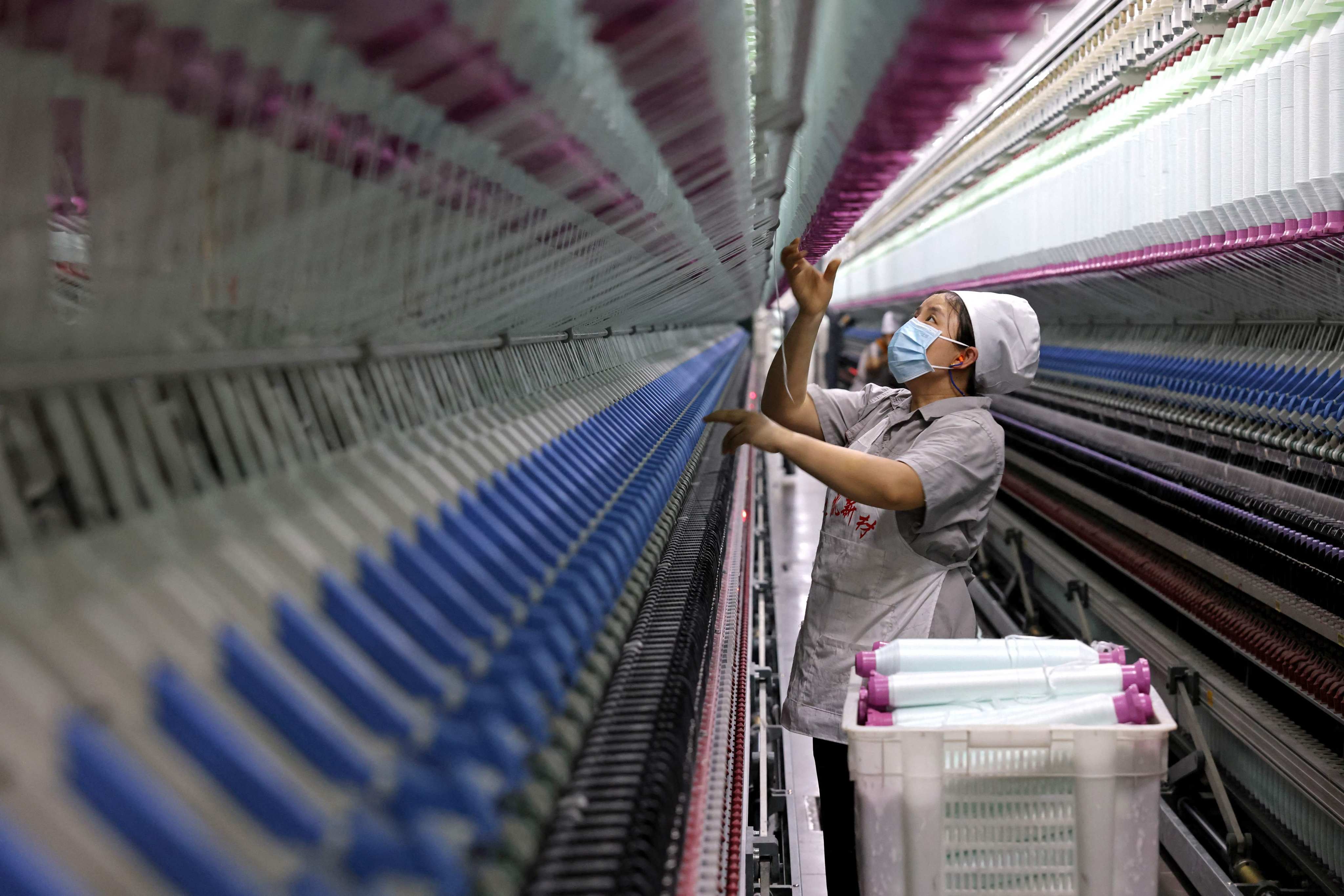 A woman works on a production line for high-end threads in China’s Shandong province. Photo: AFP