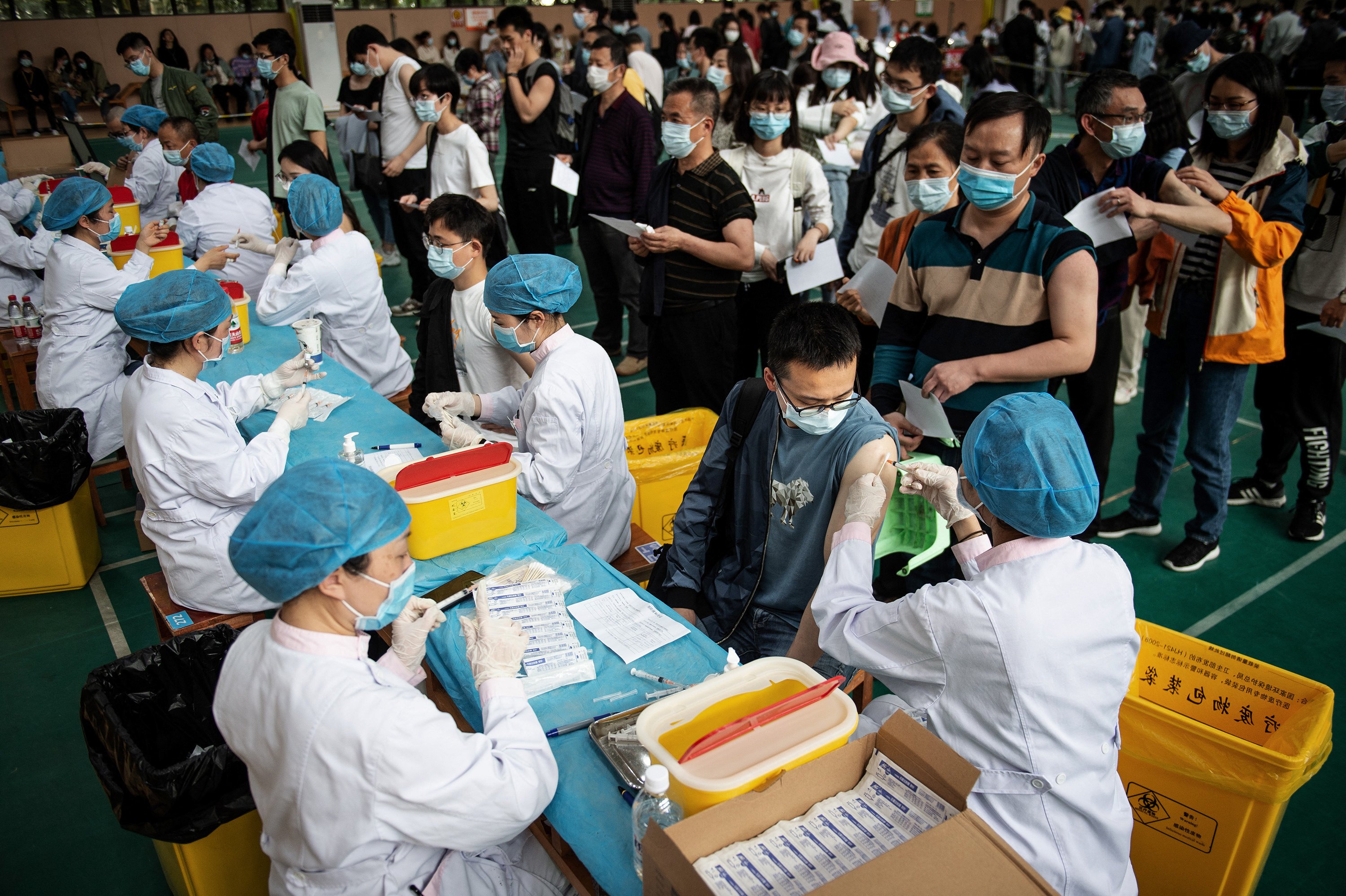 University students queue to receive the China National Biotec Group (CNBG) Covid-19 coronavirus vaccine at a university in Wuhan, in China’s central Hubei province in April 2021. Photo: AFP