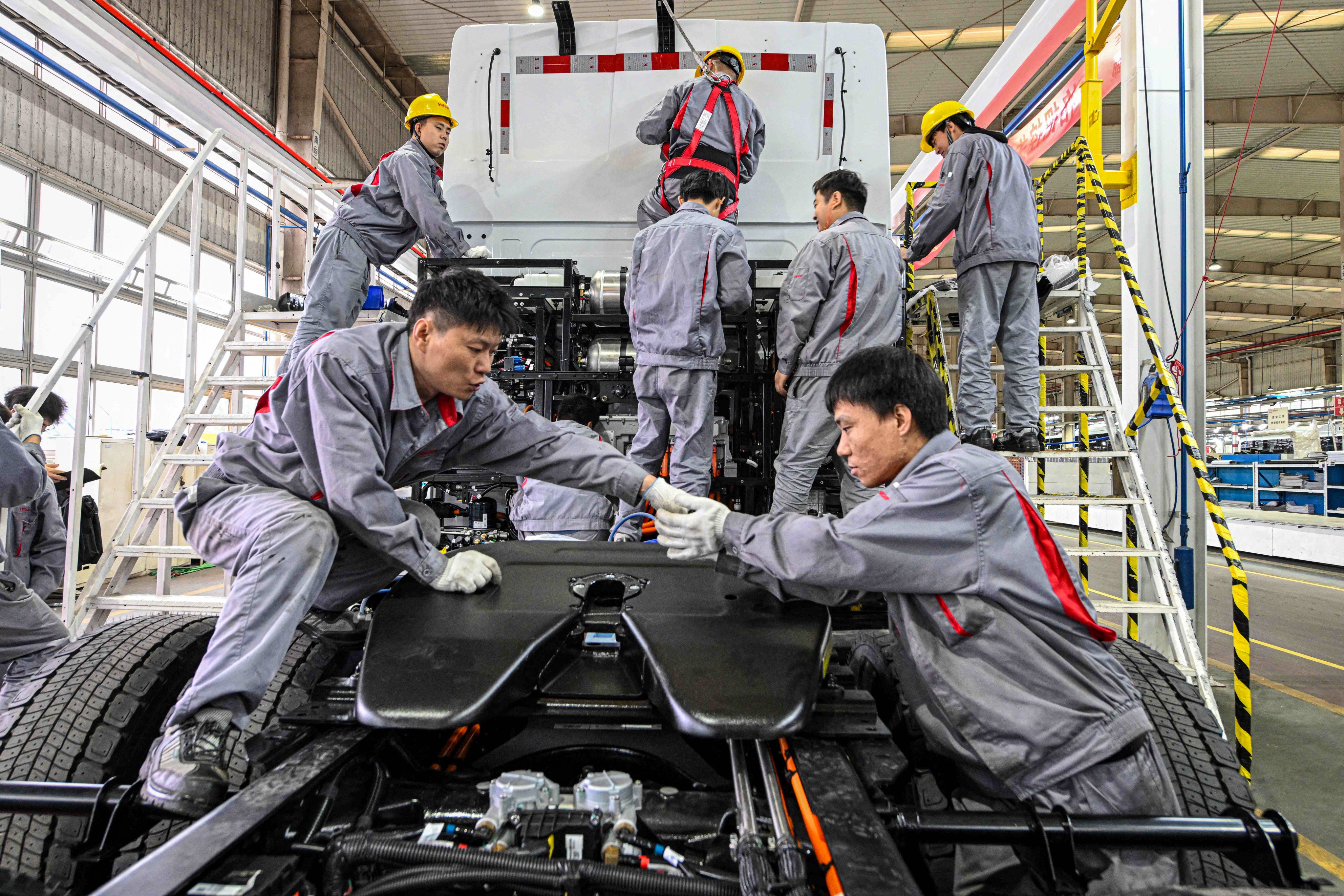 Employees work on an electric-truck assembly line in China’s Jiangsu province. The nation’s EV sector is facing problems from “involution”. Photo: AFP