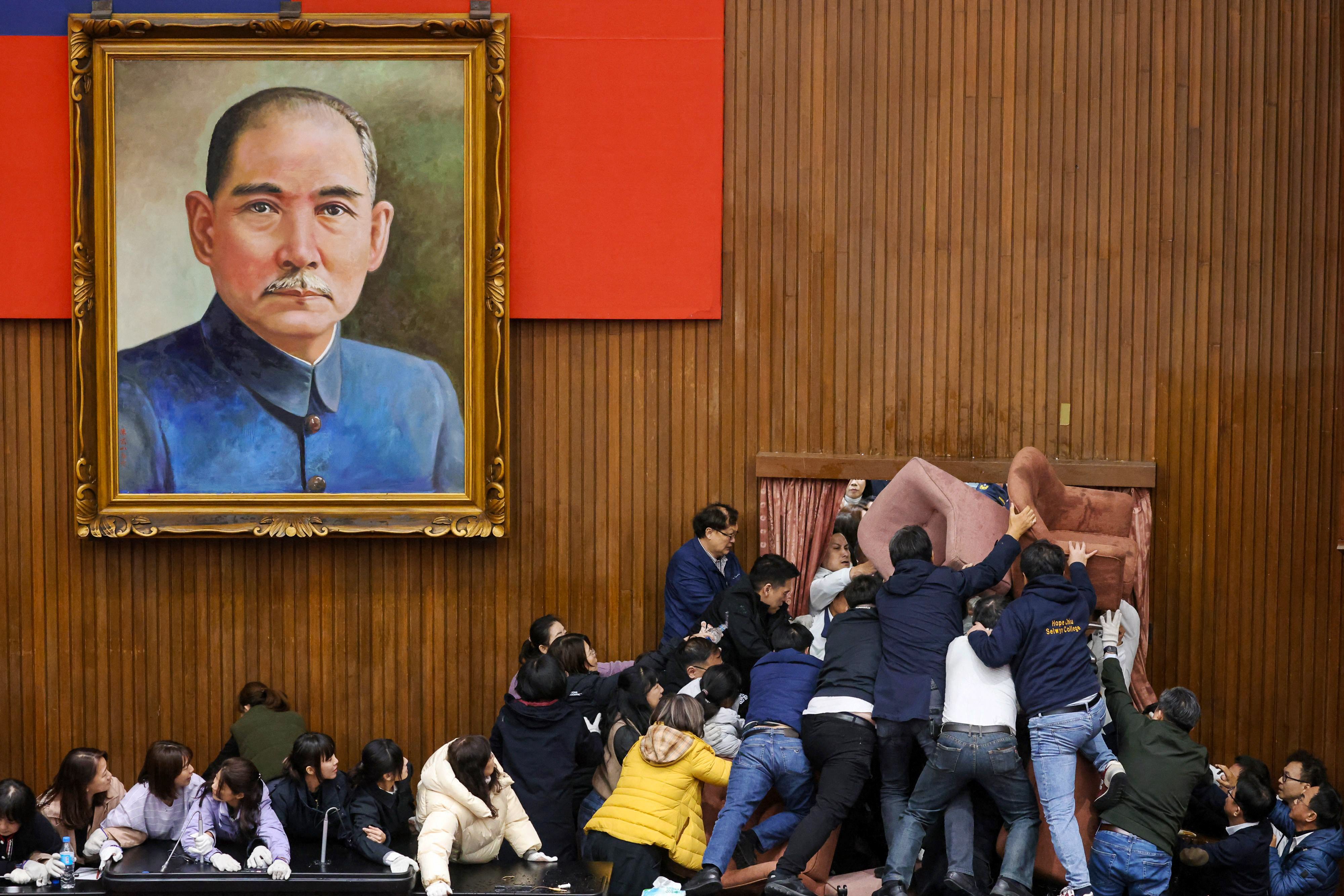 Taiwanese lawmakers brawl over a series of controversial bills on December 20 in the island’s parliament building in Taipei. Photo: AFP