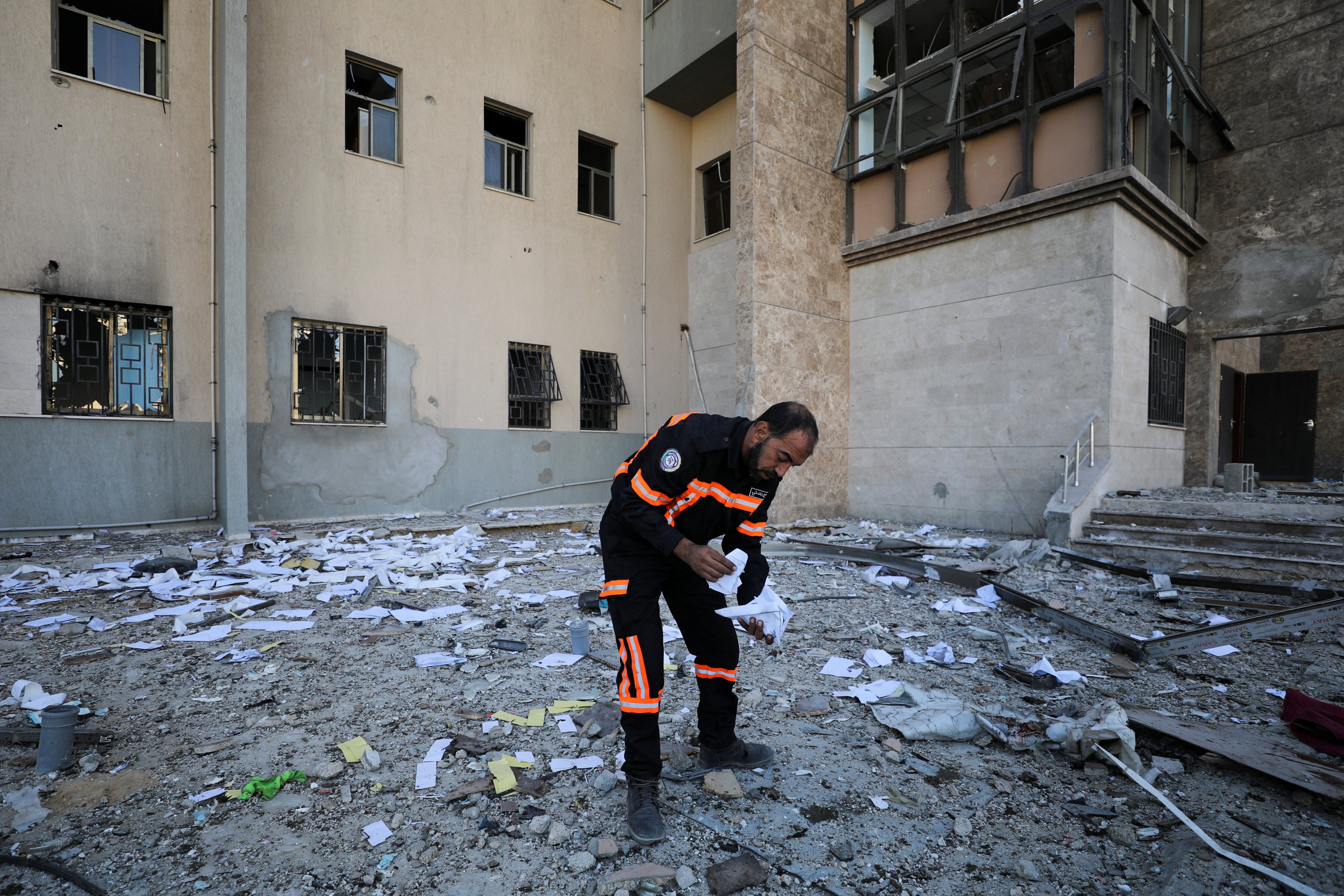 A Palestinian man inspects the site of an Israeli strike on Al-Wafaa hospital. Photo: Reuters