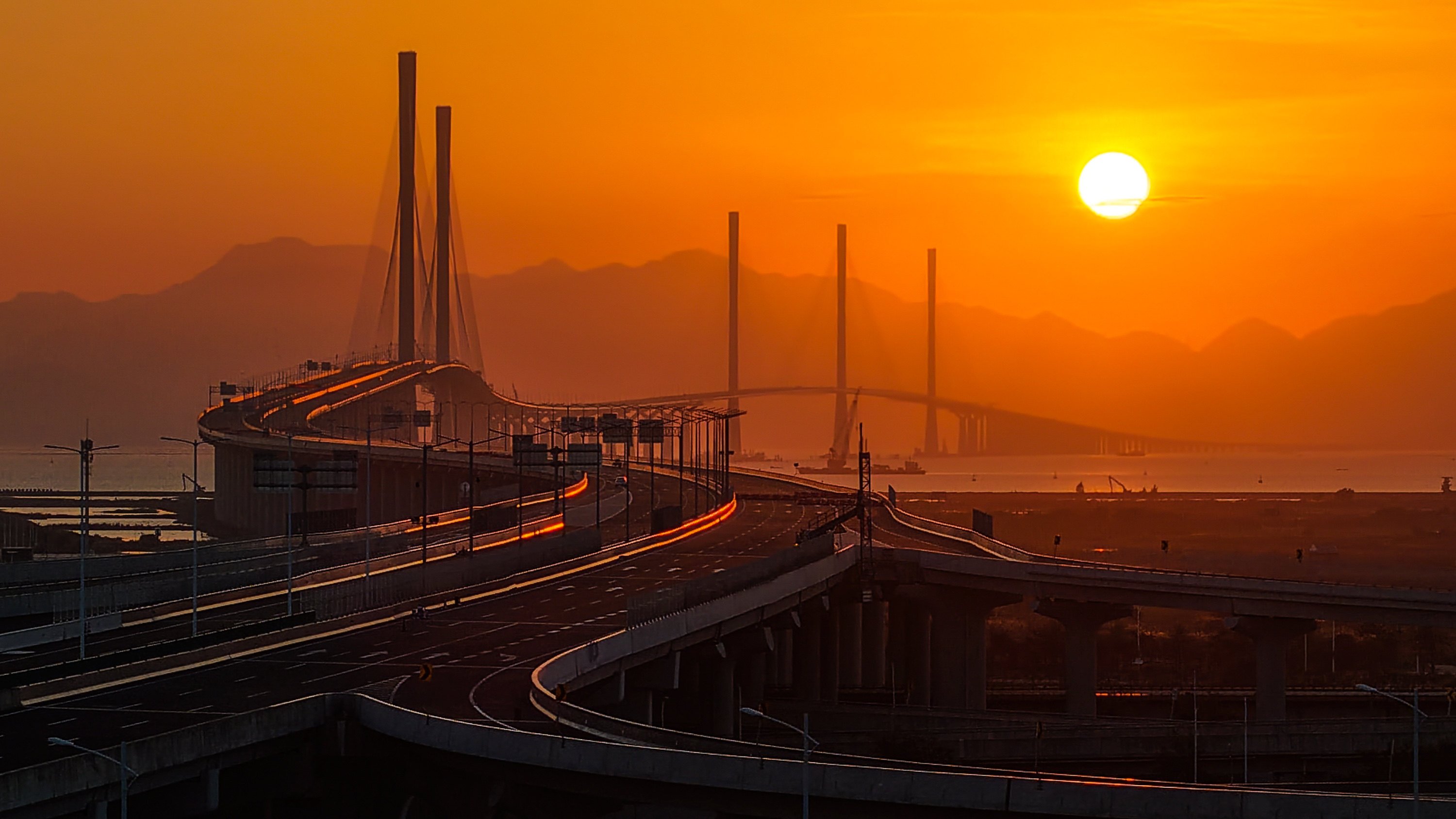 Huangmaohai Bridge, with its three striking towers, is seen in the rear-centre of this photo taken from Guangdong province; Gaolan Port Bridge (with two towers) is seen to the left. Photo: Xinhua