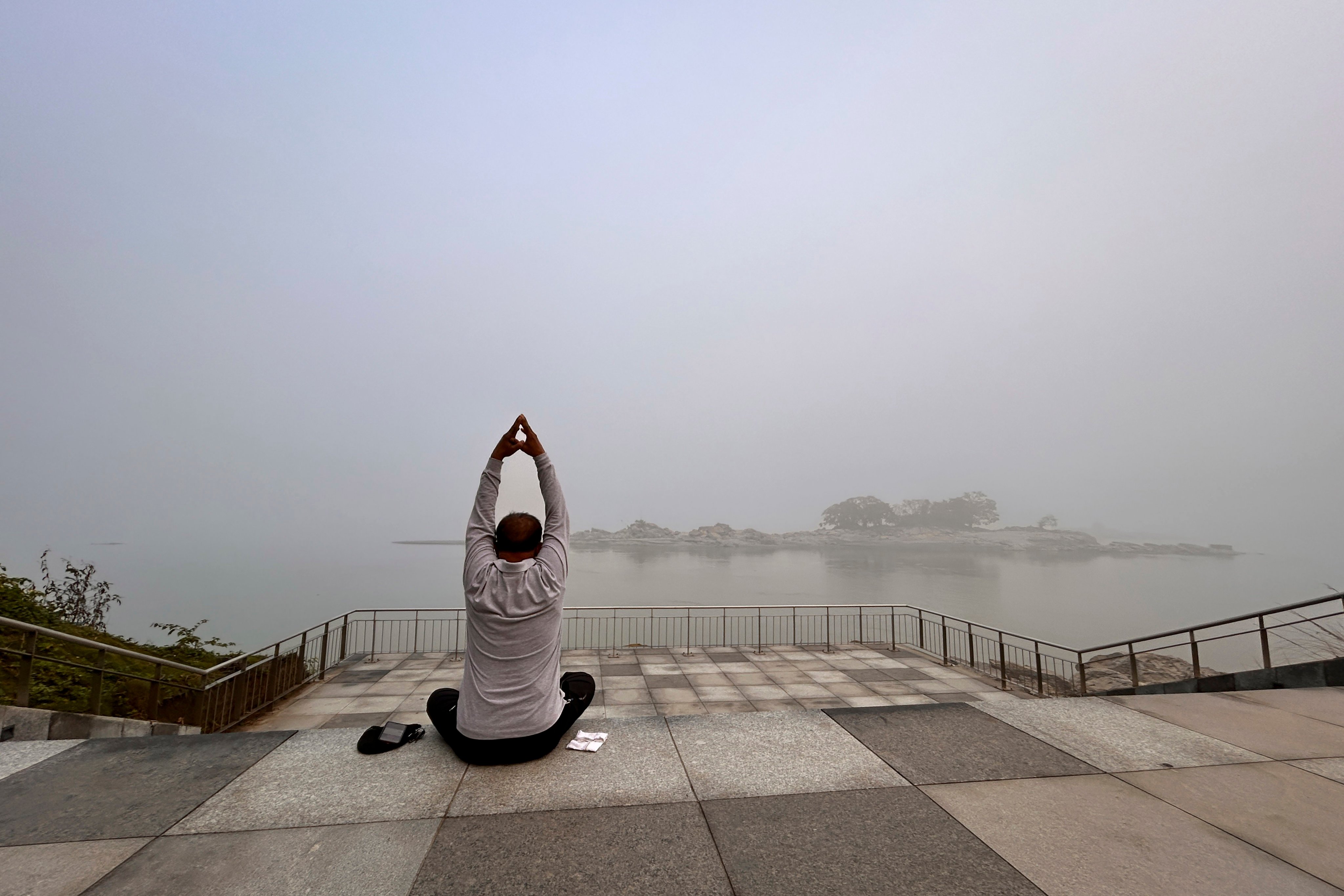 A man performs yoga on the banks of the Brahmaputra in Guwahati, India, on December 7. The river is central to the socioeconomic development of both India and China. Photo: AP 