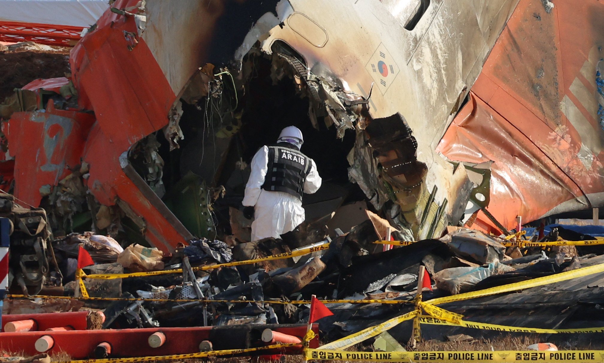 A government official investigates on Thursday at the site where a Jeju Air aircraft crashed at Muan International Airport on December 29. Photo: AFP