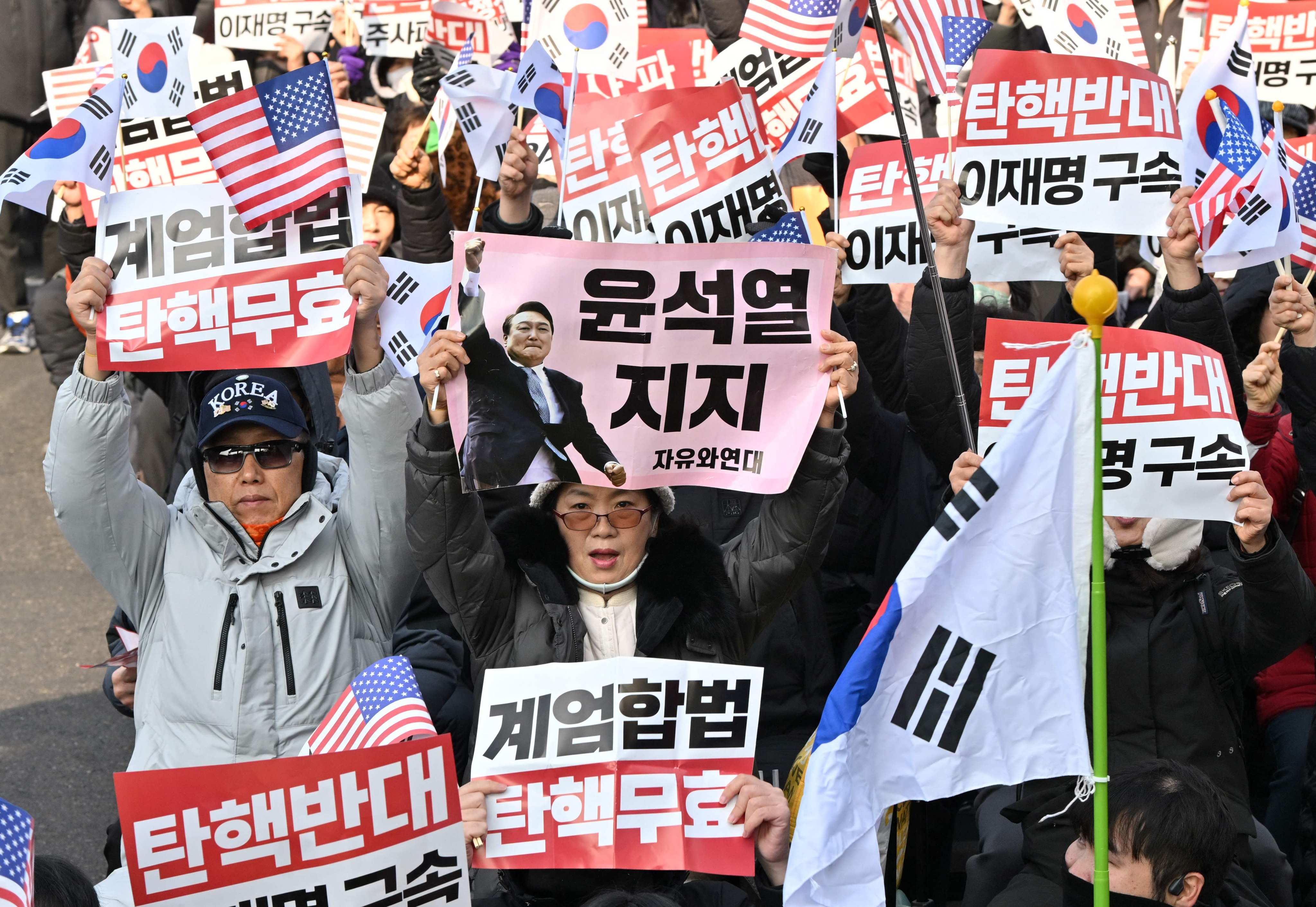 Supporters of impeached South Korean President Yoon Suk-yeol gather near his residence in Seoul on January 1. Photo: AFP