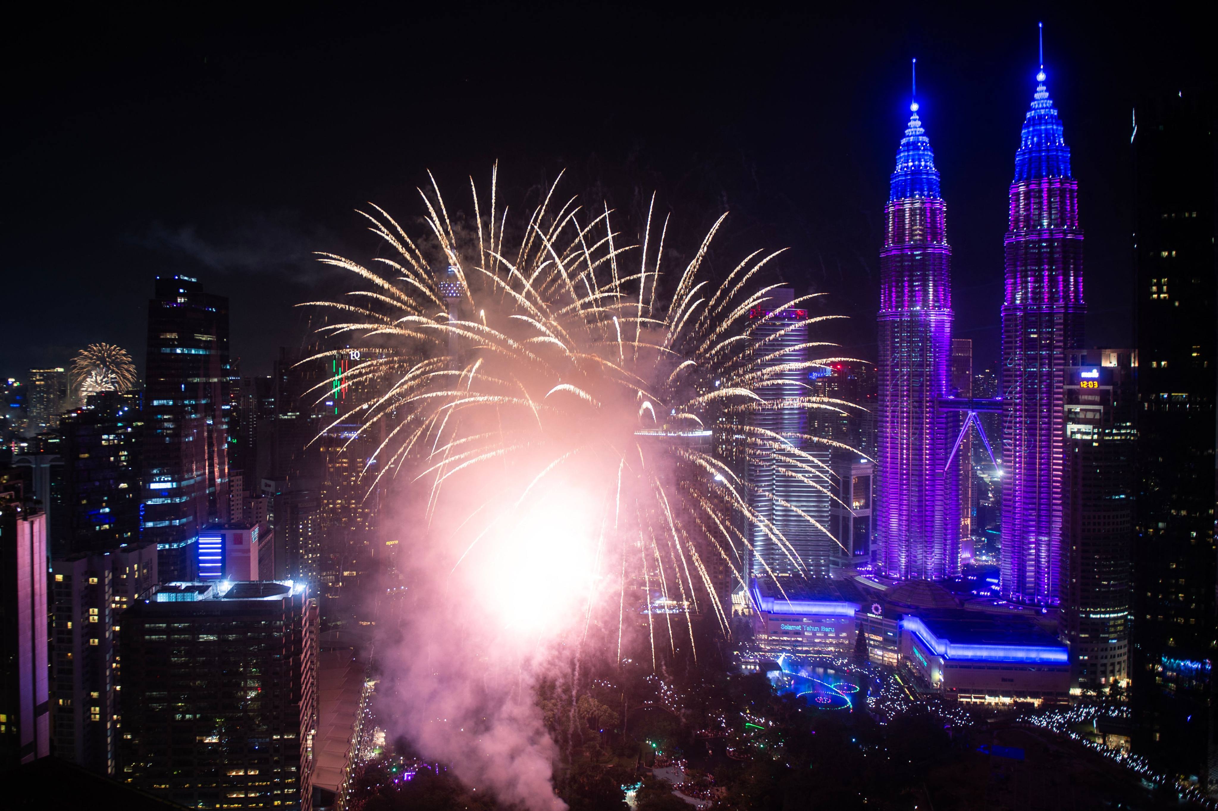 Fireworks explode over the Petronas Twin Towers during the New Year celebrations in Kuala Lumpur, Malaysia, on January 1. Photo: AFP
