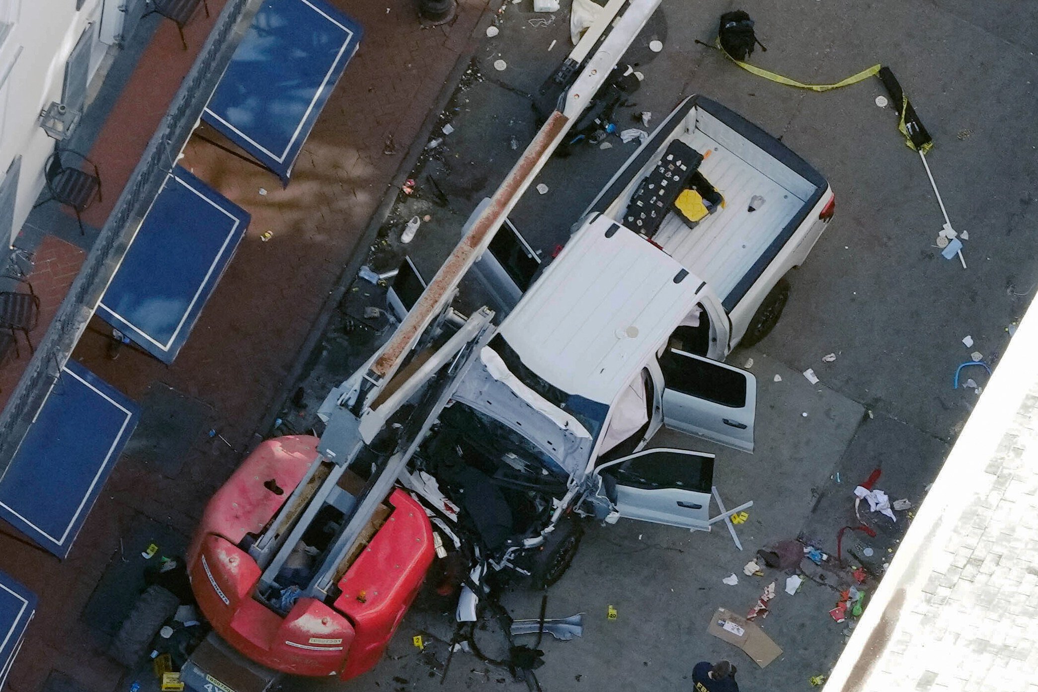 A black flag with white lettering lies rolled up on the ground behind a pickup truck was driven into a crowd in New Orleans on Wednesday. Photo: AP