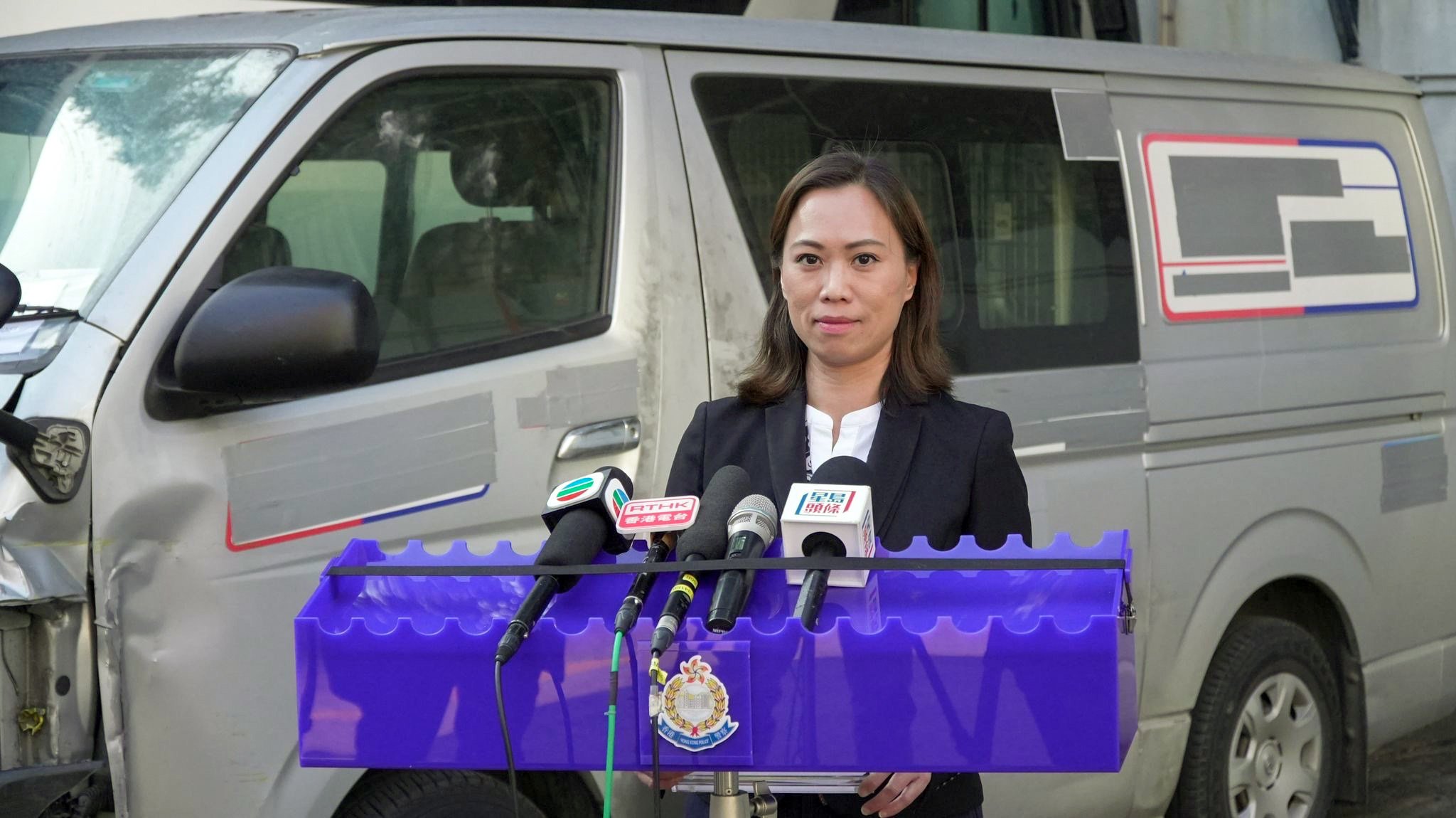 Acting chief inspector Lai Ma-yan briefs the media on the arrest, with the van involved in the case behind her.   Photo: Handout